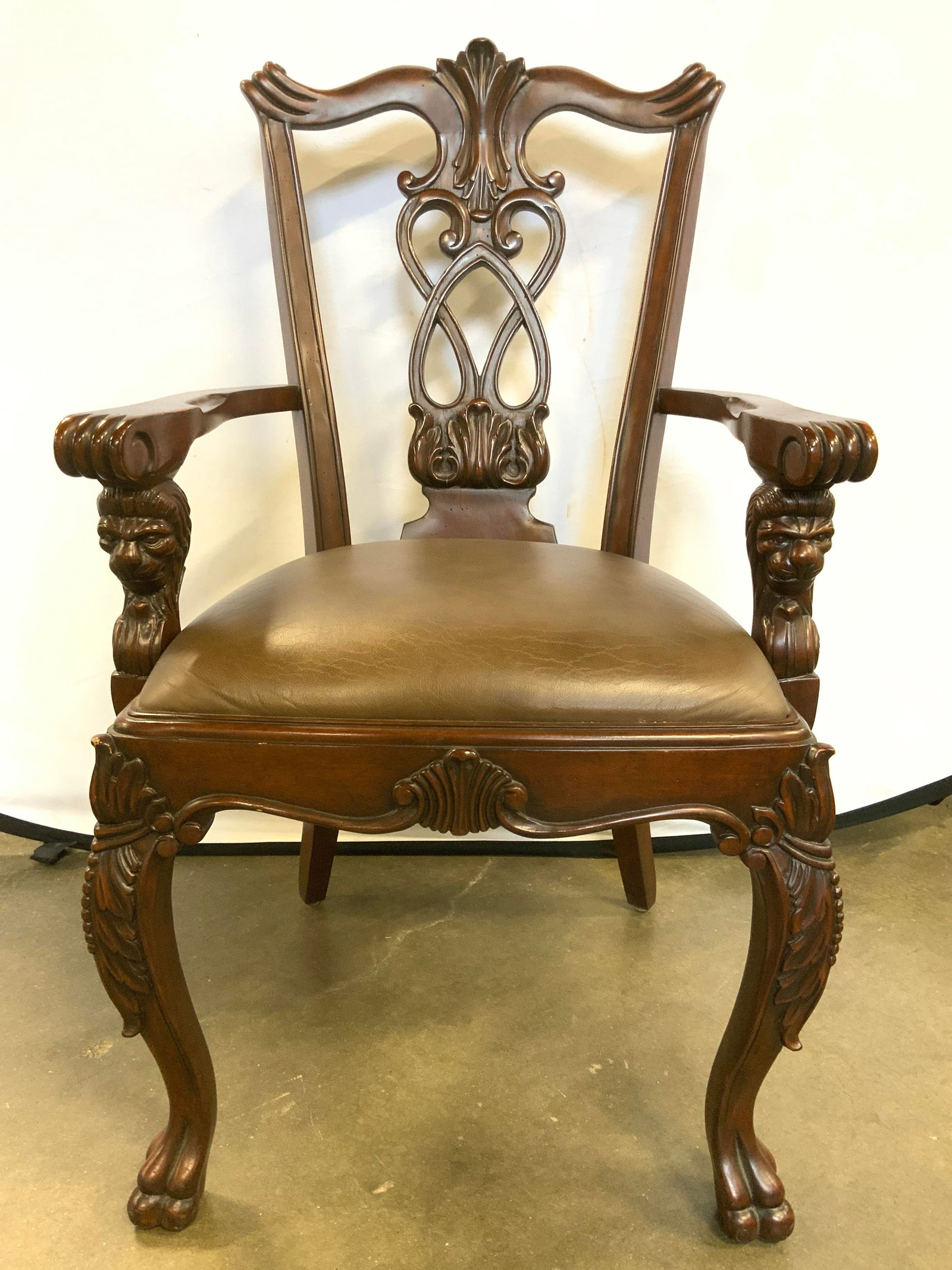 Vntg Chippendale Style Wooden End Chair: Chair is wooden. Piece appears to be vintage. Chair is Chippendale style. Piece has intricately carved front 2 paw feet, lion head arm supports & carved wooden backrest. Chair has brown toned leather 