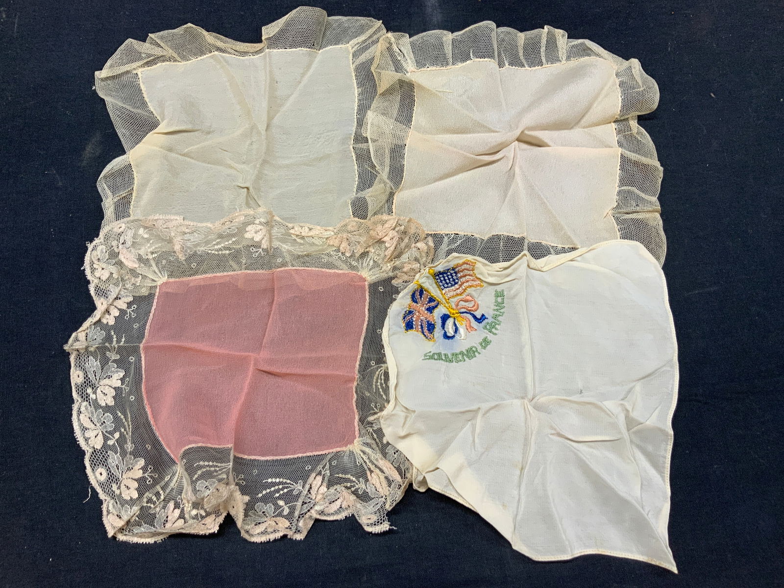 Lot 4 Vtg Lace & Embroidered Handkerchiefs: Lot of 4 vintage handkerchiefs with lace edges and silk centers. 2 off white silk handkerchief with cross hatched lace edges and 1 pink toned handkerchief with floral motifs on lace edges and 1 linen