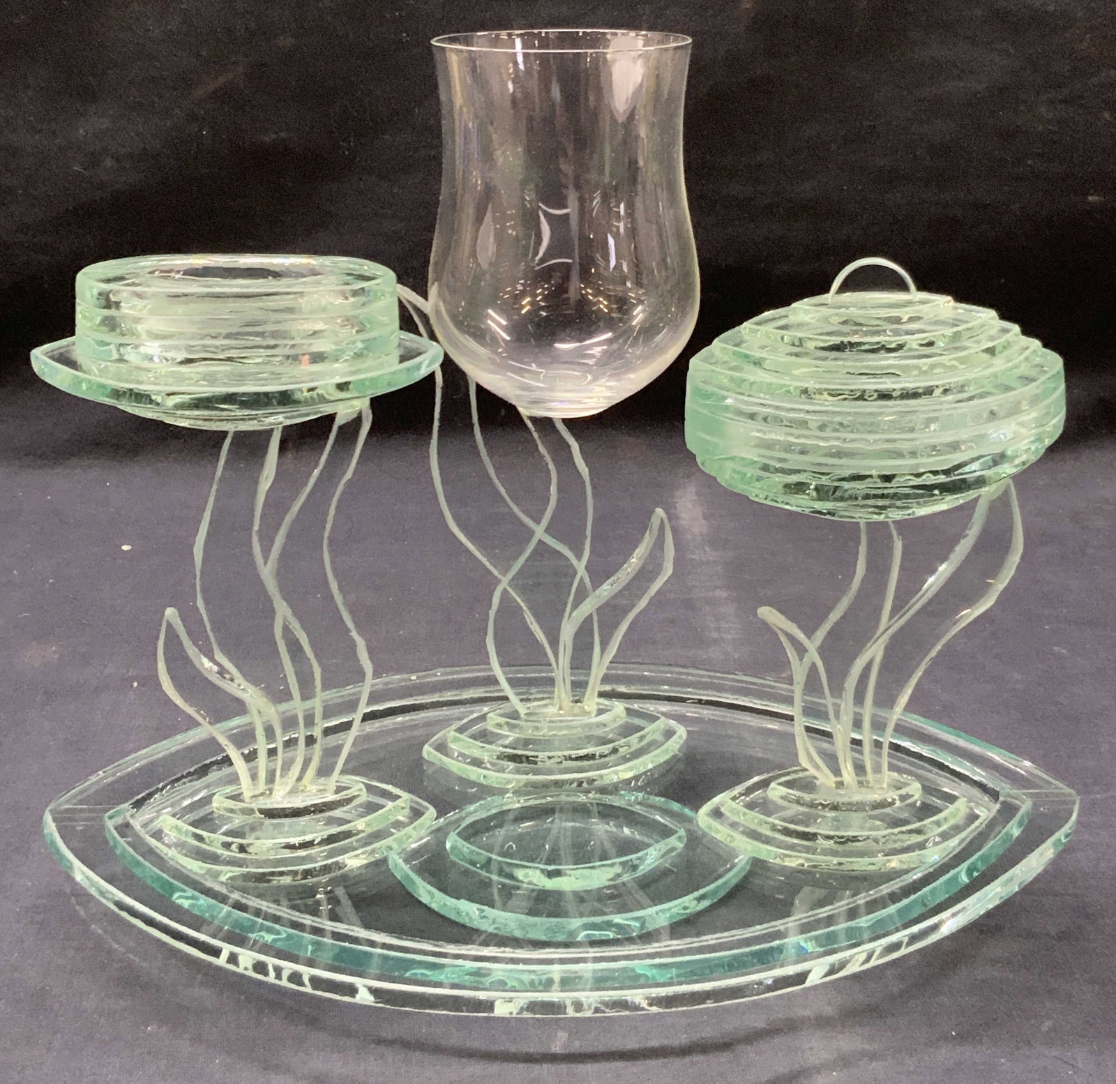 Signed Barak Cut Glass Havdalah Set: Havdalah set of cut glass ware. 1 saucer, open faced footed candle holder, a lidded perfume tool and 1 wine glass. Each piece is made of cut green toned glass with leaf motifs. Saucers is approx 10.5 