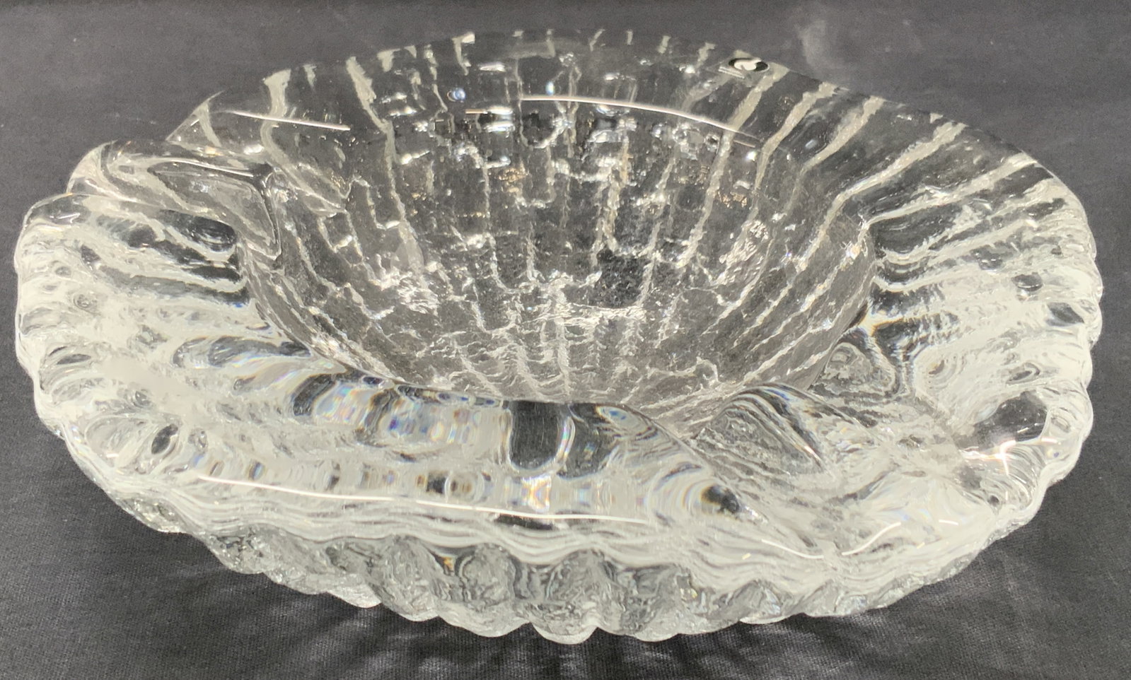 Pukeberg Art Glass Ashtray Vessel, Sweden: Off white, light blue toned art glass ash tray with textured underside. Marked pukeberg Sweden on sticker. Approx 2.25 inches tall and 8 inch diameter, Moderate wearing to glass due to age and use. Ar