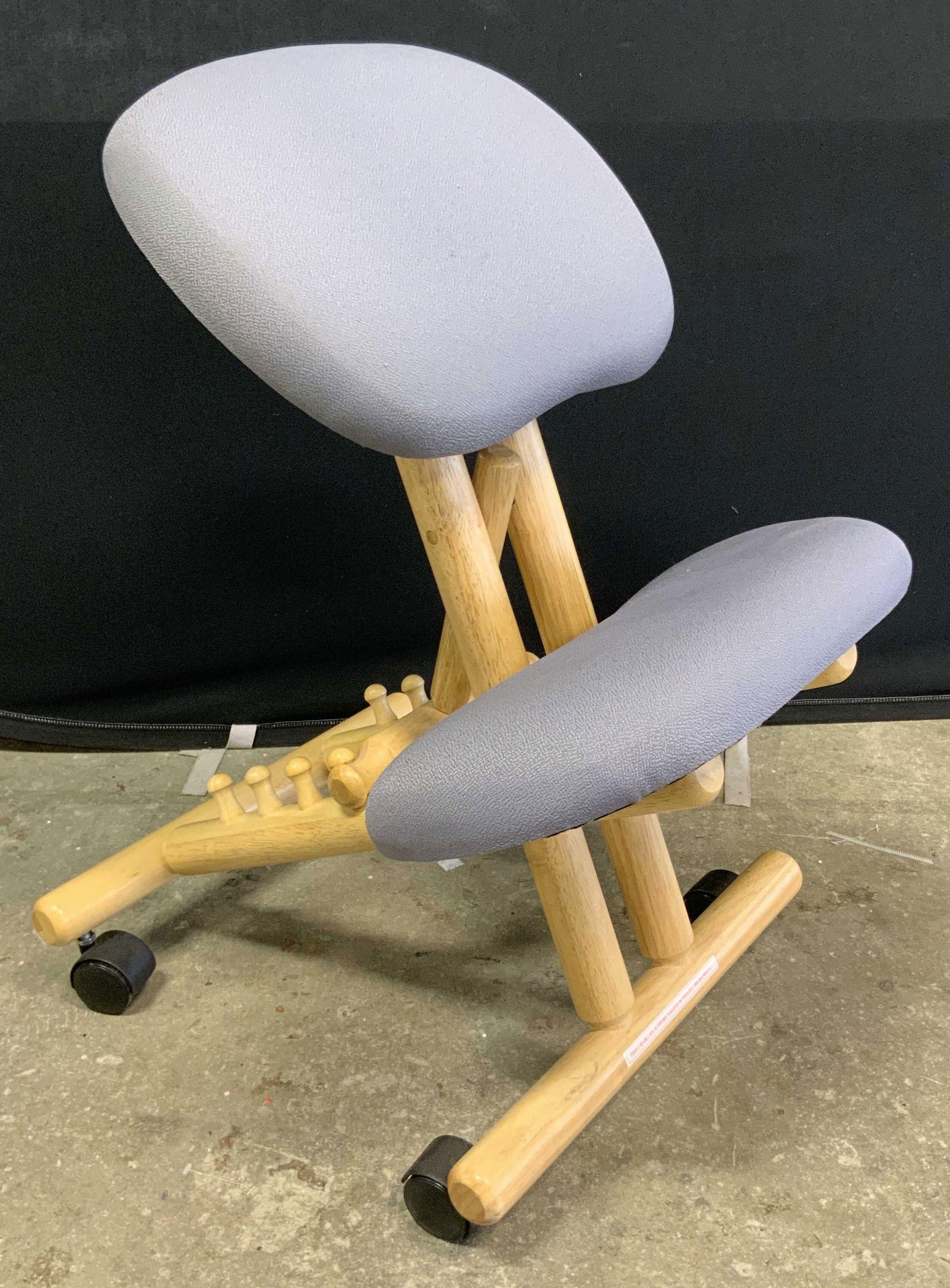 Gray Ergonomic Kneeling Office Chair, Wheeled: Ergonomic Kneeling Office Chair in Gray on wheels. Adjustable. Crafted from wood, composite, and fabric materials. Measures approx. 28H x 18W x 18D in. Some wear consistent with use. Chairs, seating,
