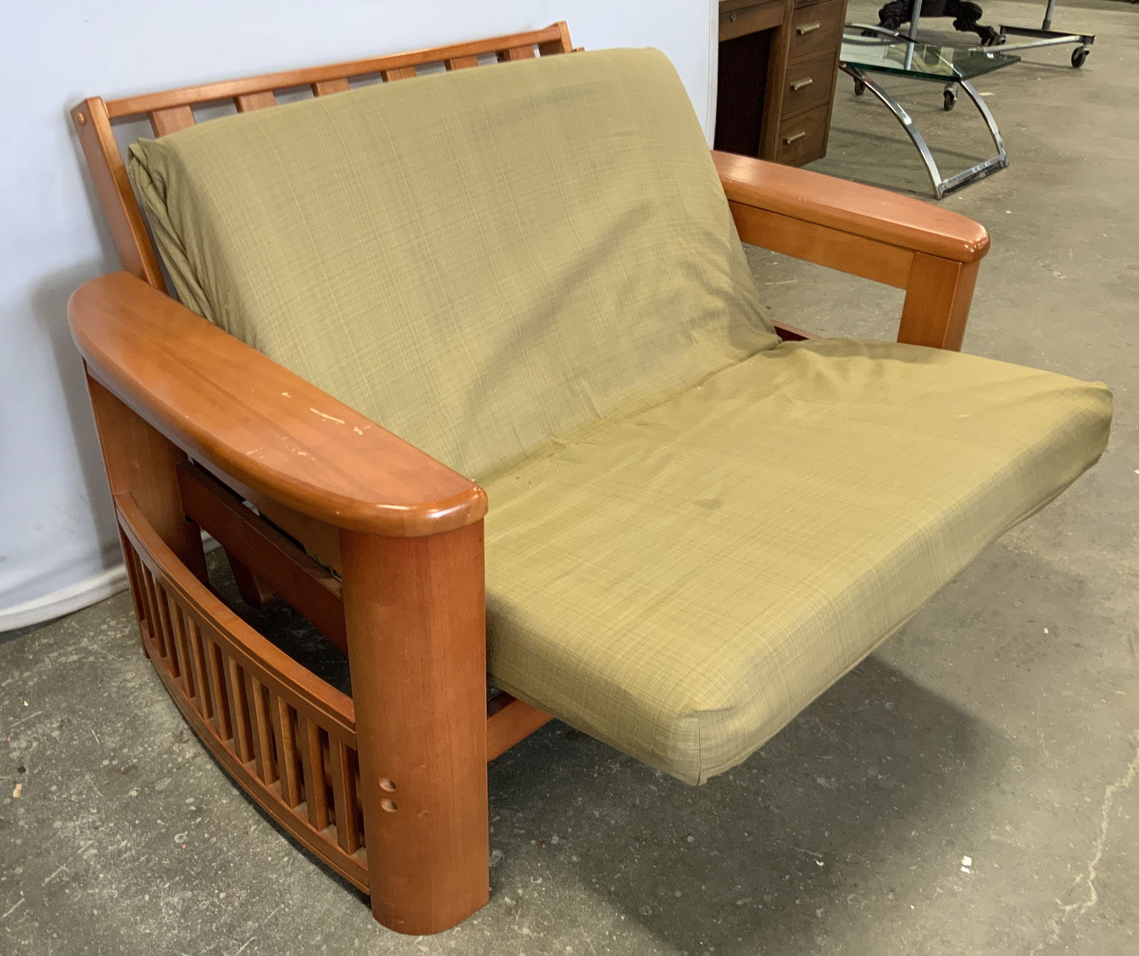 Mission Style Wooden Futon Armchair: A mission style wooden futon armchair. Light hued semi glossy wood finish frame. Light green hued futon mattress. Not tested for function. Some losses and discoloration present. Frame measures approx.