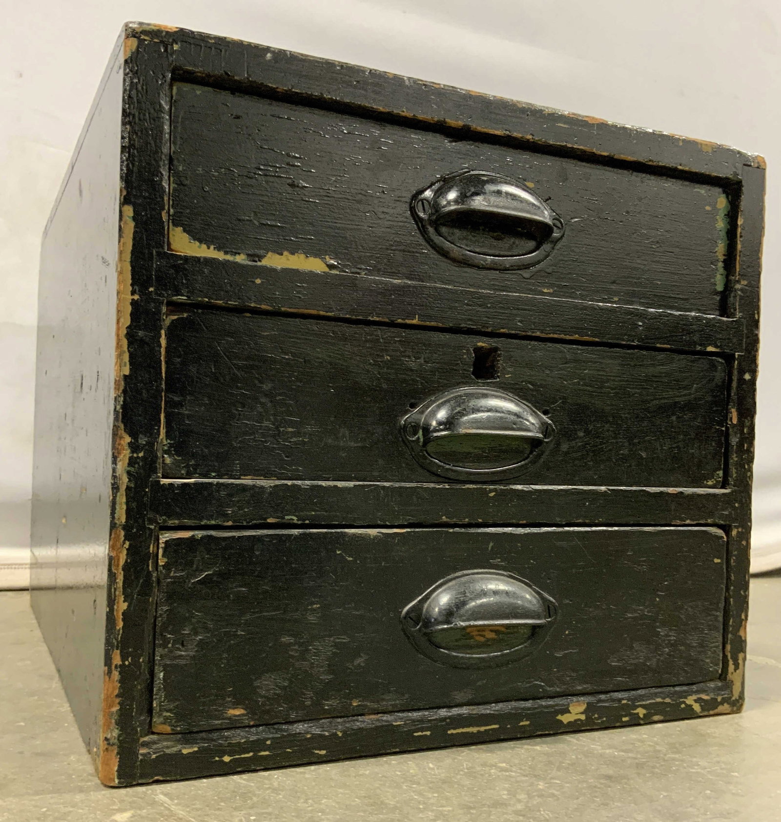 Vintage Wooden Chest Of Drawers Black: Chest is black toned and wooden. Piece has 3 drawers each with black toned metal drawer pulls. Chest appears to be vintage. Measures approximately 21 inches deep 15 inches wide 13 inches tall. Chest, 