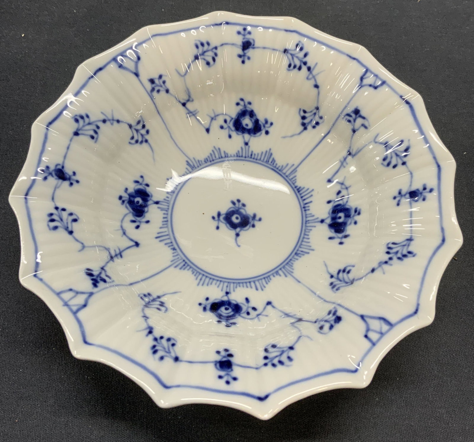 Royal Copenhagen Blue Lace Porcelain Bowl, Denmark: Royal Copenhagen porcelain bowl in blue lace pattern. Scalloped rim and textured surface. Hand painted. Trademarked to underside. Made in Denmark. Measures approx. 6.5 x 1.75 inches. Royal Copenhagen,