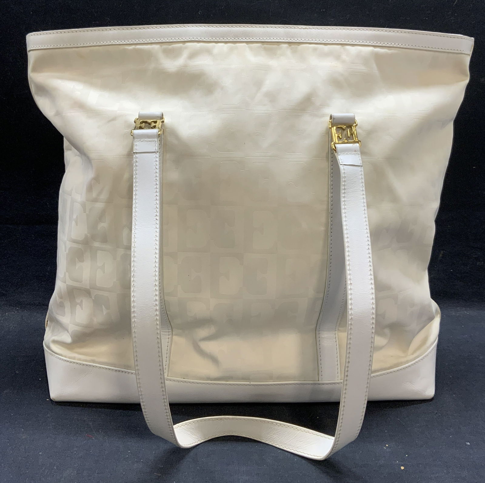 ESCADA White Monogram Handbag, Italy: ESCADA white monogram handbag. Nylon with leather trim. Signed to interior. Made in Italy. 1 zipper pocket and top zipper closure. Measures approx. 14.25 x 6.5 x 14 inches. Some blemishes observed. ES