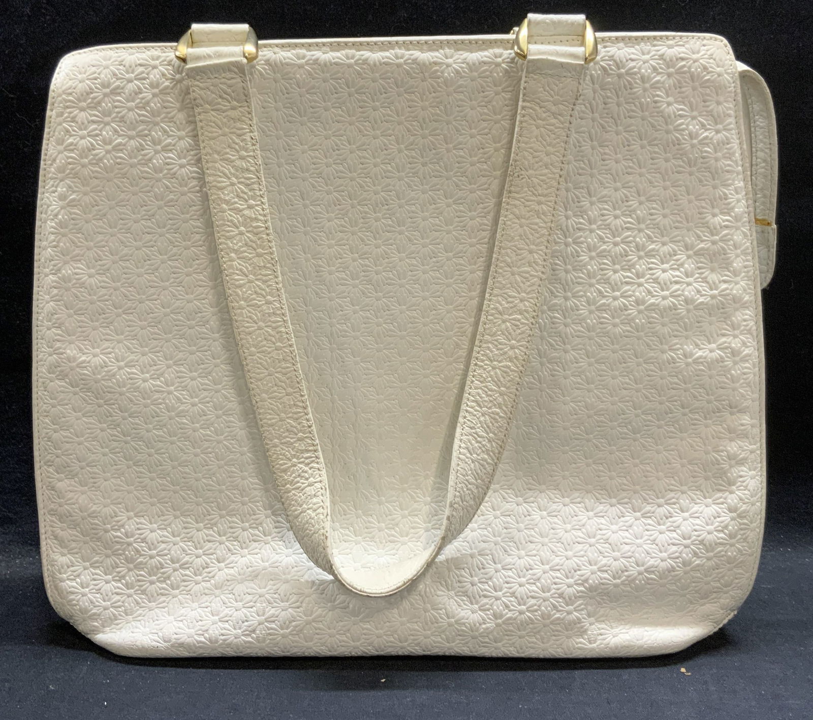 ESCADA White Leather Flower Handbag: ESCADA white leather handbag with embossed raised flower motif. Signed to interior. 1 zippered pocket and top zipper closure. Measures approx. 13 x 4 x 11.75 inches. Includes Marc Jacobs dust bag. Som