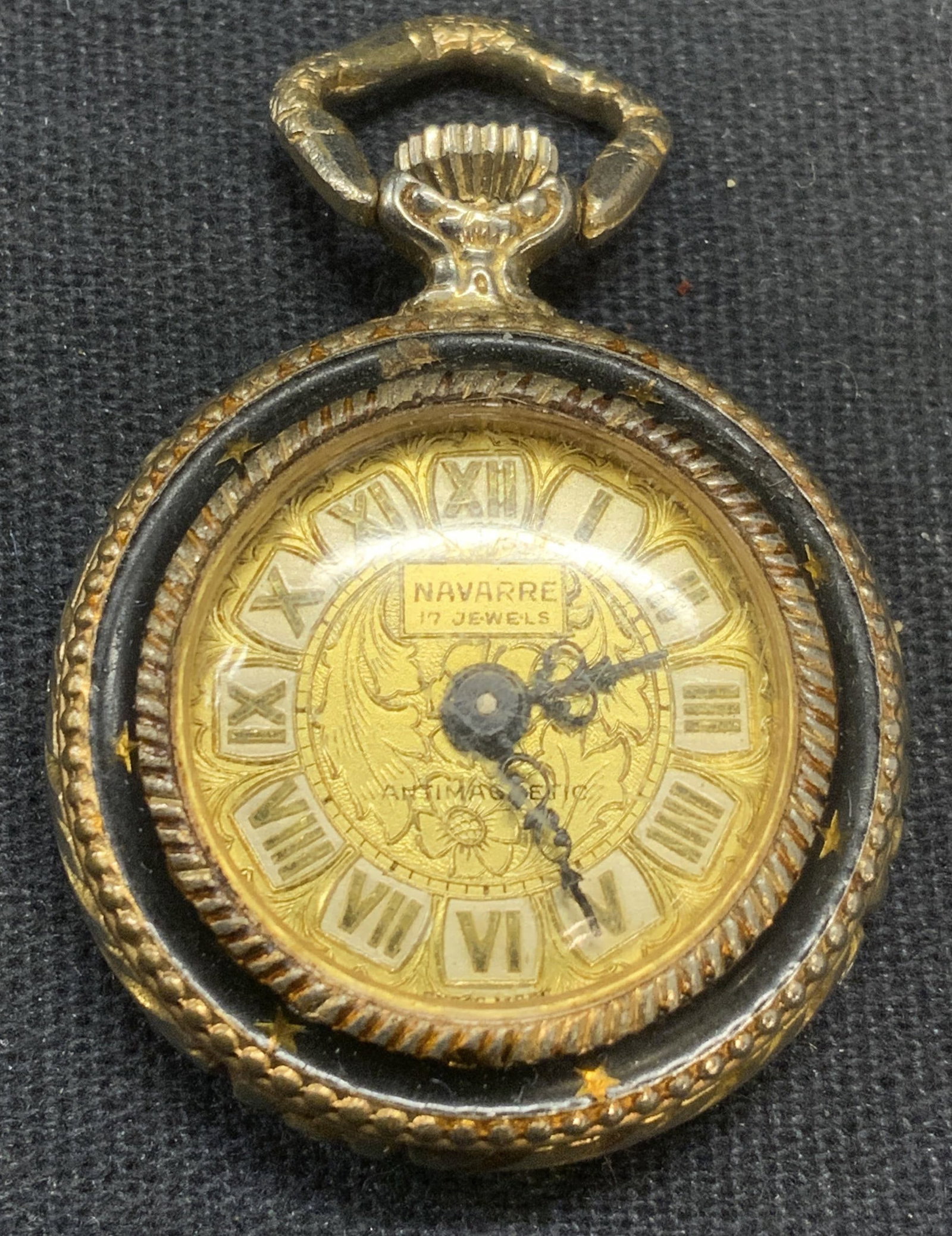 Vintage Navarre Gold Tone Pocket Watch: Vintage Navarre gold tone pocket watch with embossed floral scroll case, signed on watch face. Measures approx. 1 inch diameter. Includes jewelry box. Not tested for function. Some scratching observed