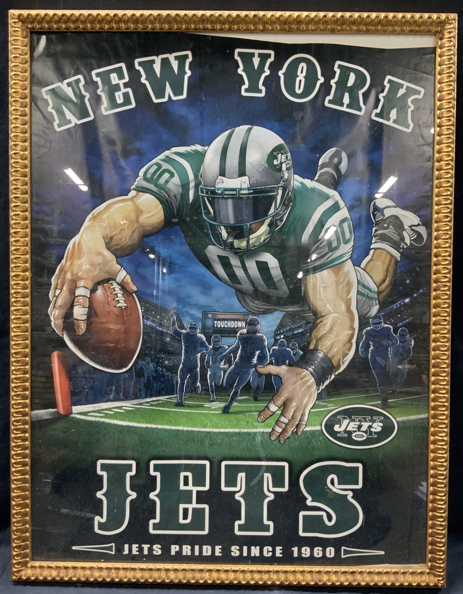 Framed New York Jets Football Lithograph: New York jets poster reading, jets price since 1960 Depicting a player lunging towards the ball with touchdown in the background. Framed with a gold leafed wooden carved frame with raise notches on ex