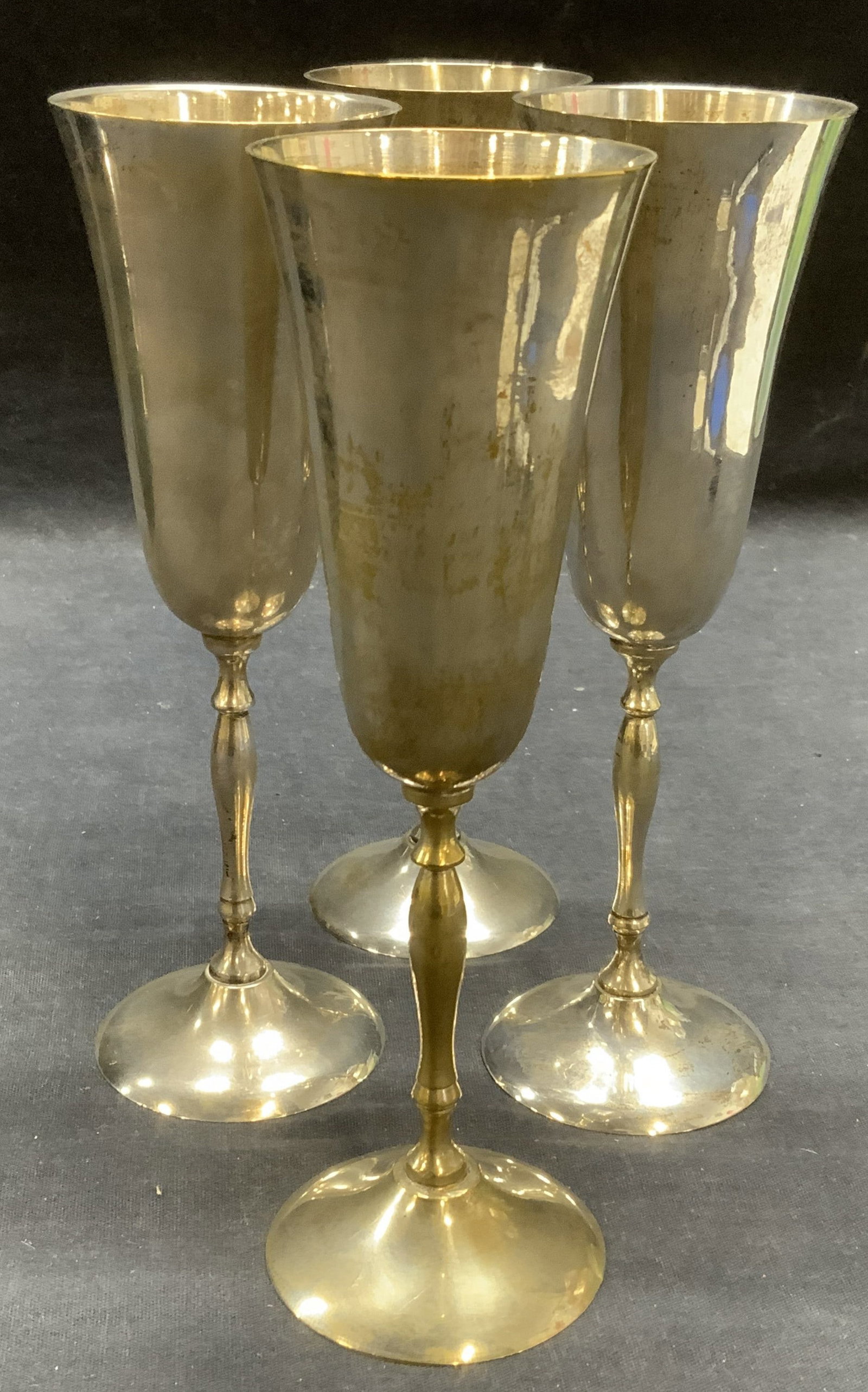 Set 4 Silver Plated Wine Glasses, India: Set of 4 silver plated wine glasses. Fluted body and tapered stem. Made in India. Measure approx. 2.25 x 7.5 inches each. All pieces have some surface wear including scratching and tarnishing observed