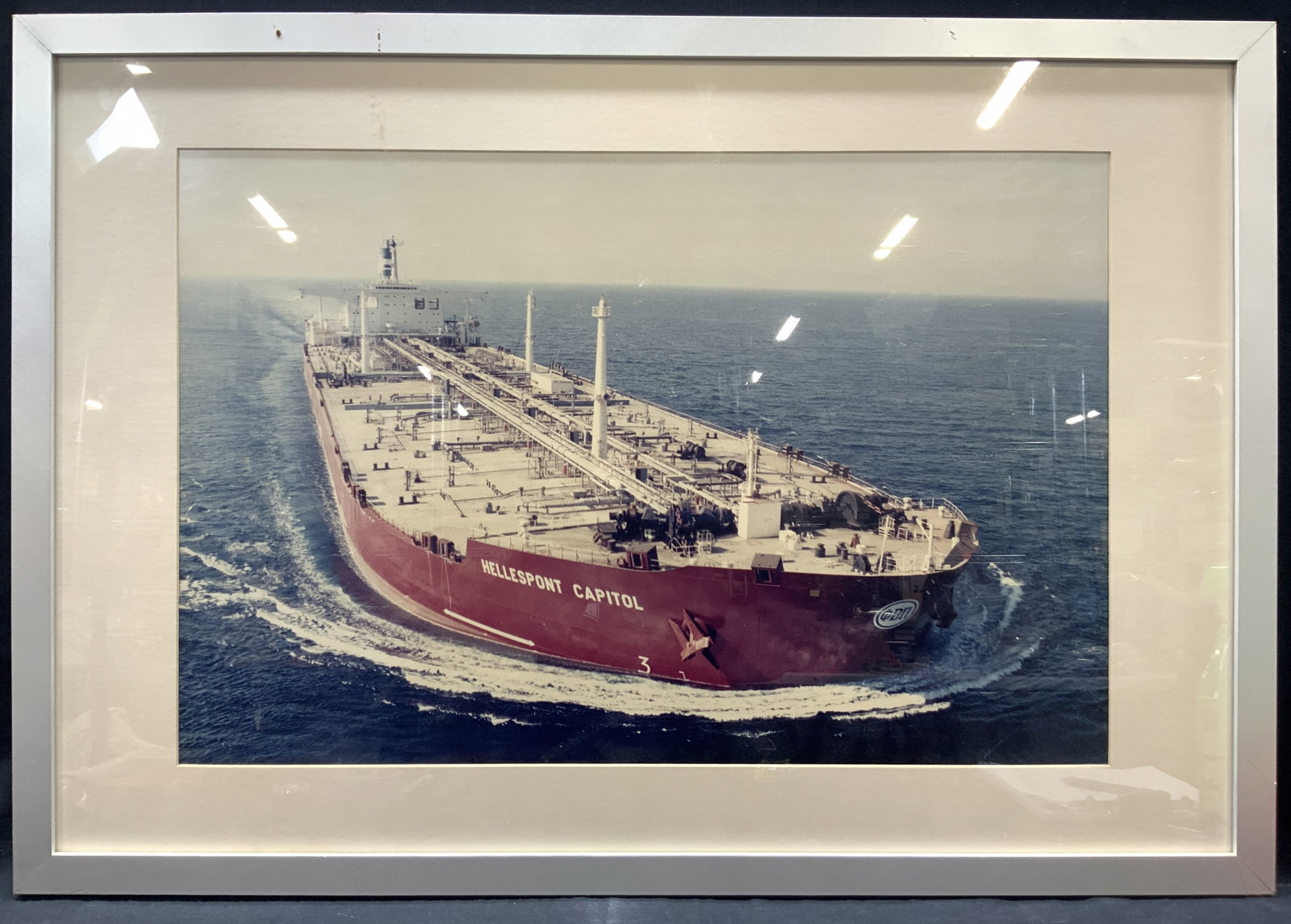 Hellspont Capitol Crude Oil Tankard Photograph 3.25ft: Colored photograph of the Hellespont Capitol crude oil tankard Framed in a silver toned wooden frame with off white mat board, approximately 27 x 39 inches window measures 19 x 29 inches Moderate wear