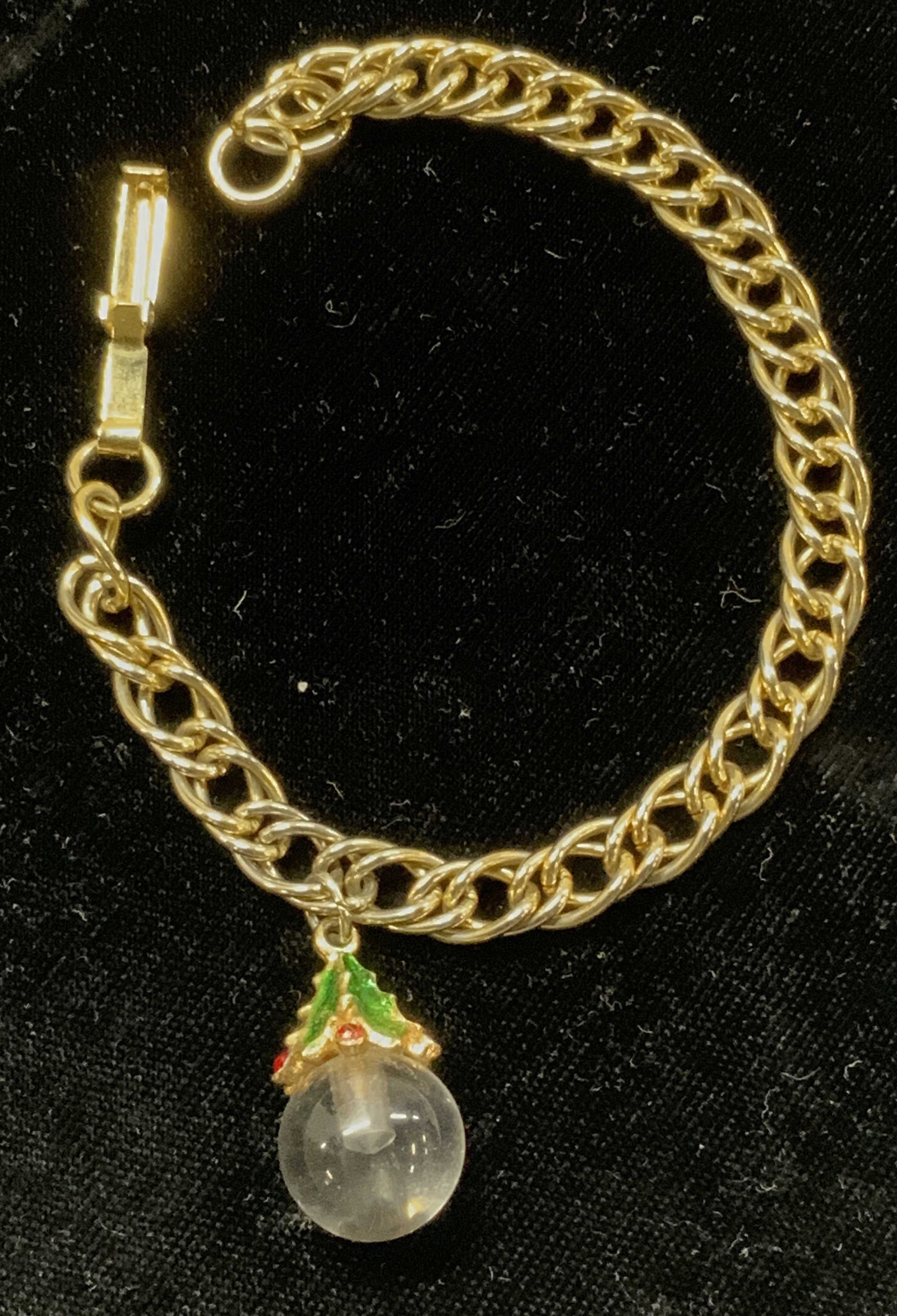 Christmas Charm Chain Bracelet: Box clasp on a gold tone chain with a singular Christmas charm of an enamel Christmas tree on clear round glass. 7 in. Long chain. Charm is 1 in. Long. vintage jewelry, Estate Jewelry, Costume Jewelry