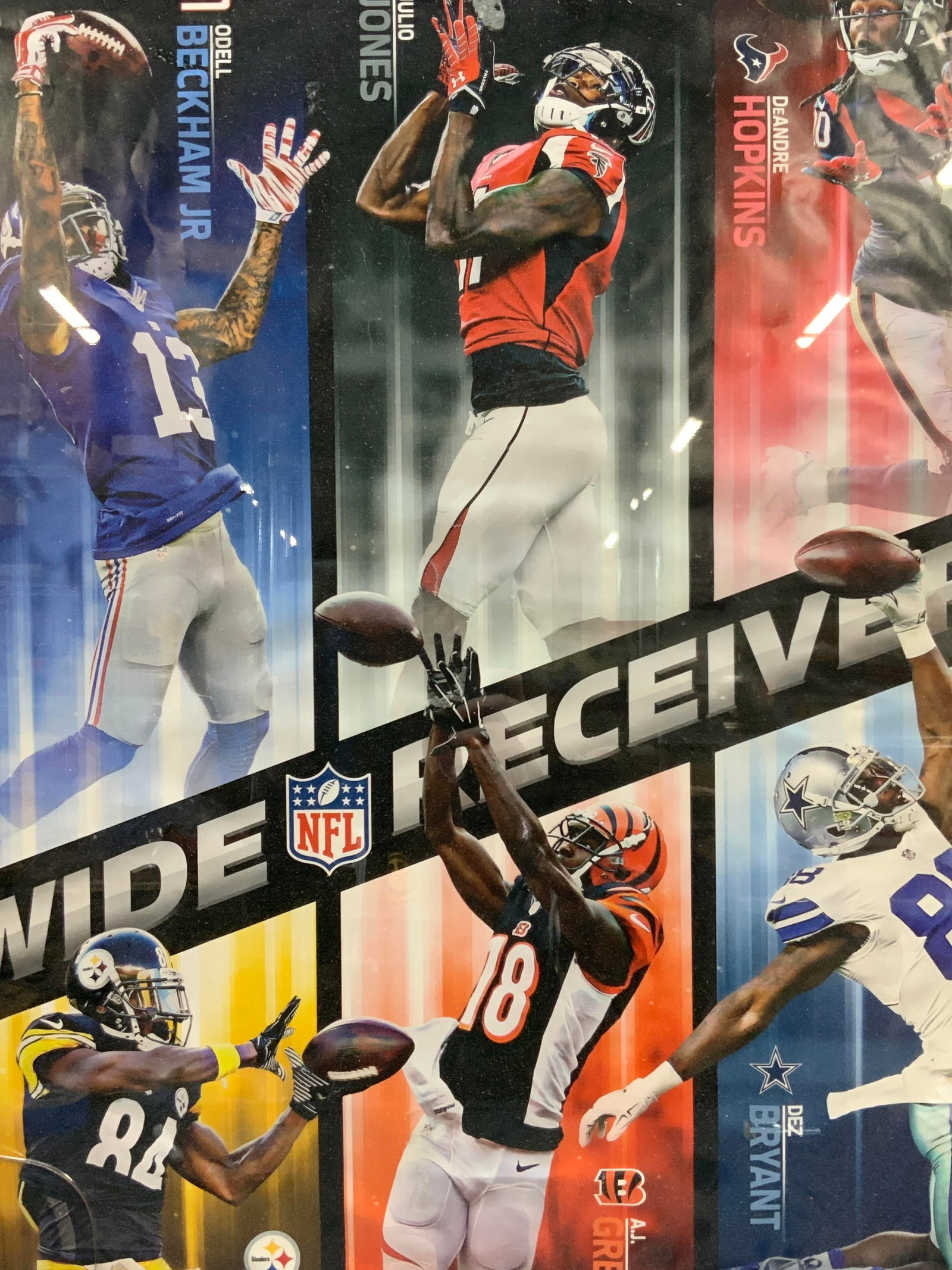 NFL Wide Receivers Lithograph: National football league poster of the wide receivers from the NFL teams, with images of the players. Approx 32 x 22 inches window measures 29 x 20 inches. Framed in a black tones carved wooden frame.
