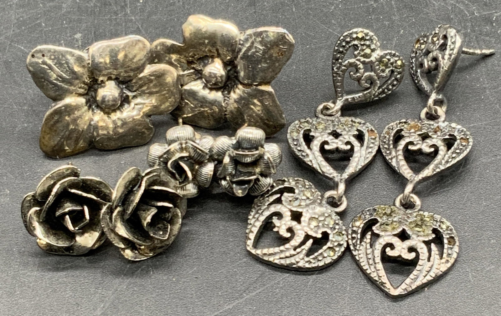 Lot 4 STERLING SILVER & Silver Tone Metal Earrings: Four vintage pairs of silver tone metal and sterling silver earrings. Marcasite heart drop earrings stamped 925, total weight .20 ozt. Measures approx. 1.5L x .5W in. The other three pairs of earrings