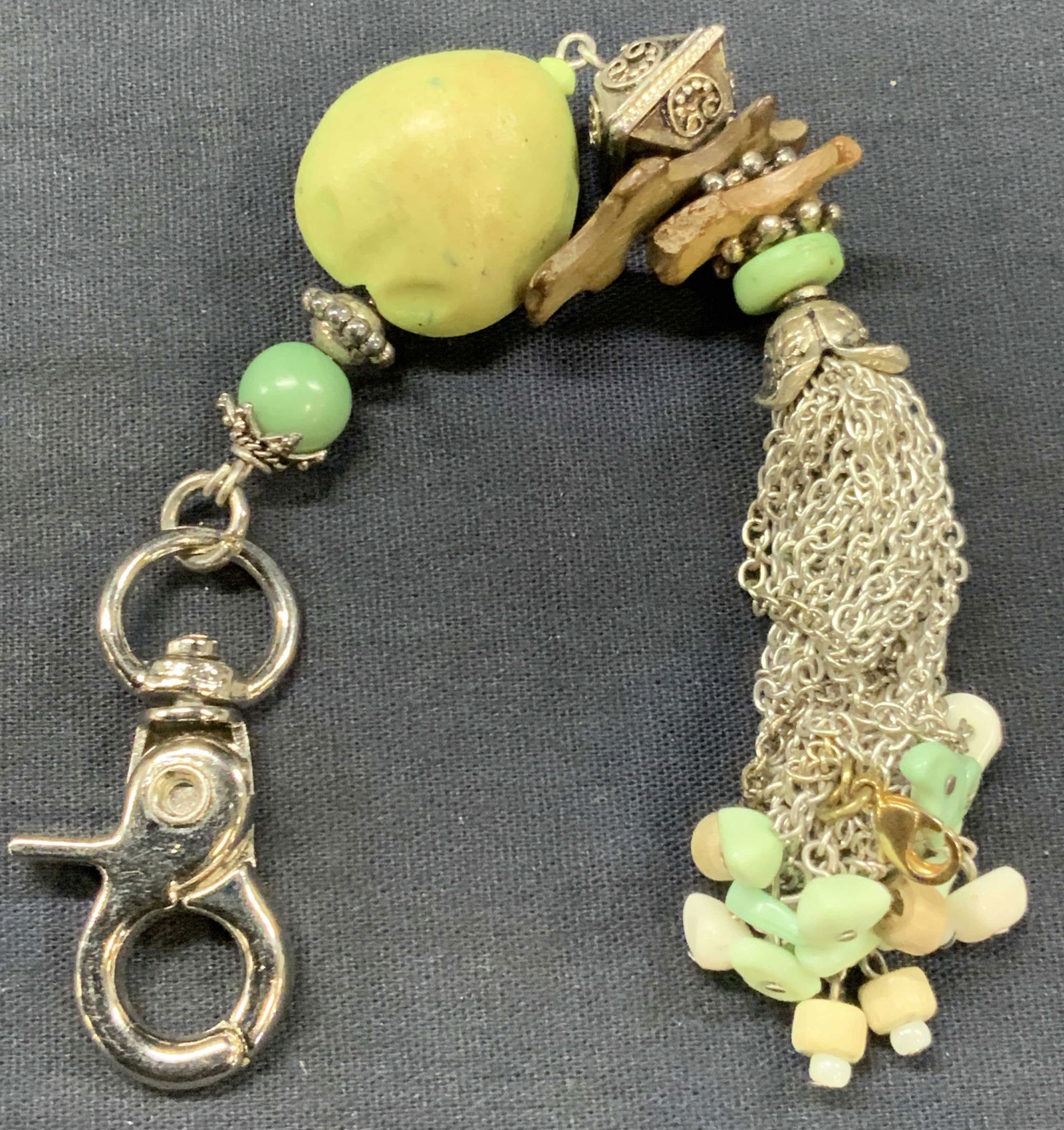 Arts & Crafts Beaded Stone Keychain: Arts and crafts made keychain made with beads and green tones with chain tassel on end and stone slab bead in center of key chain Approx, 8 inches long. Moderate wearing to beads due to and use. Keych