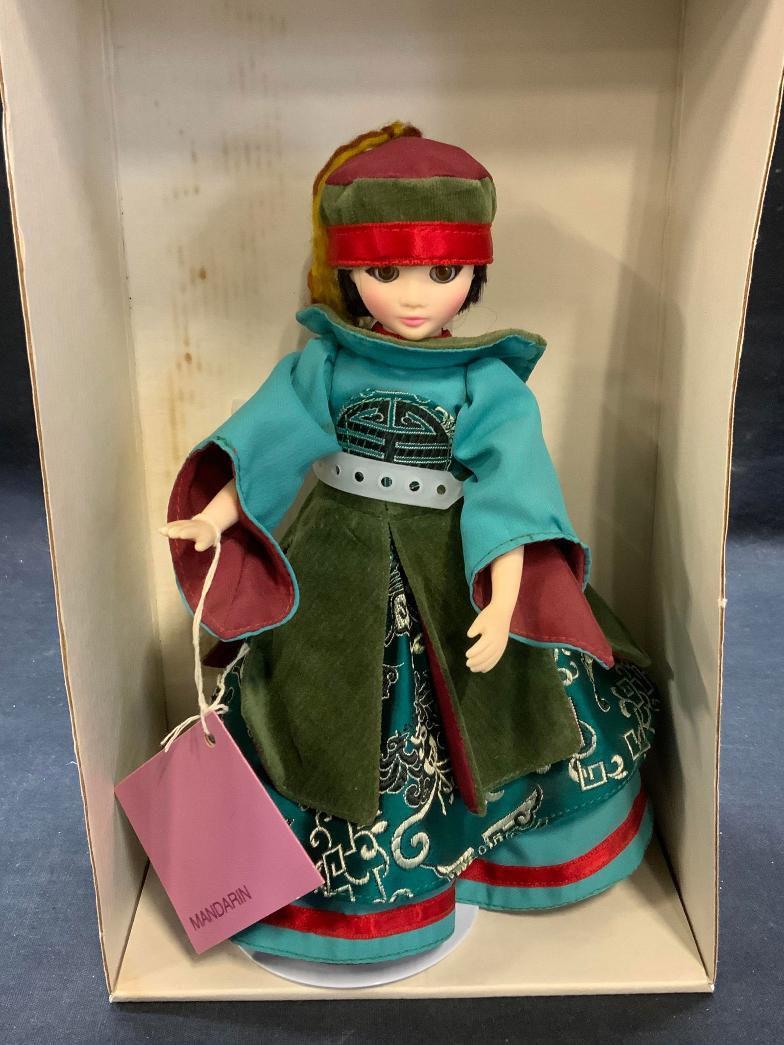 Suzanne Gibson Reeves International Mandarin Doll: Vintage Suzanne Gibson dolls from Reeves International Mandarin doll. Composed of plastic and fabric. Includes original box. Doll measures approx. 8.25 inches long. Some surface wear consistent with e