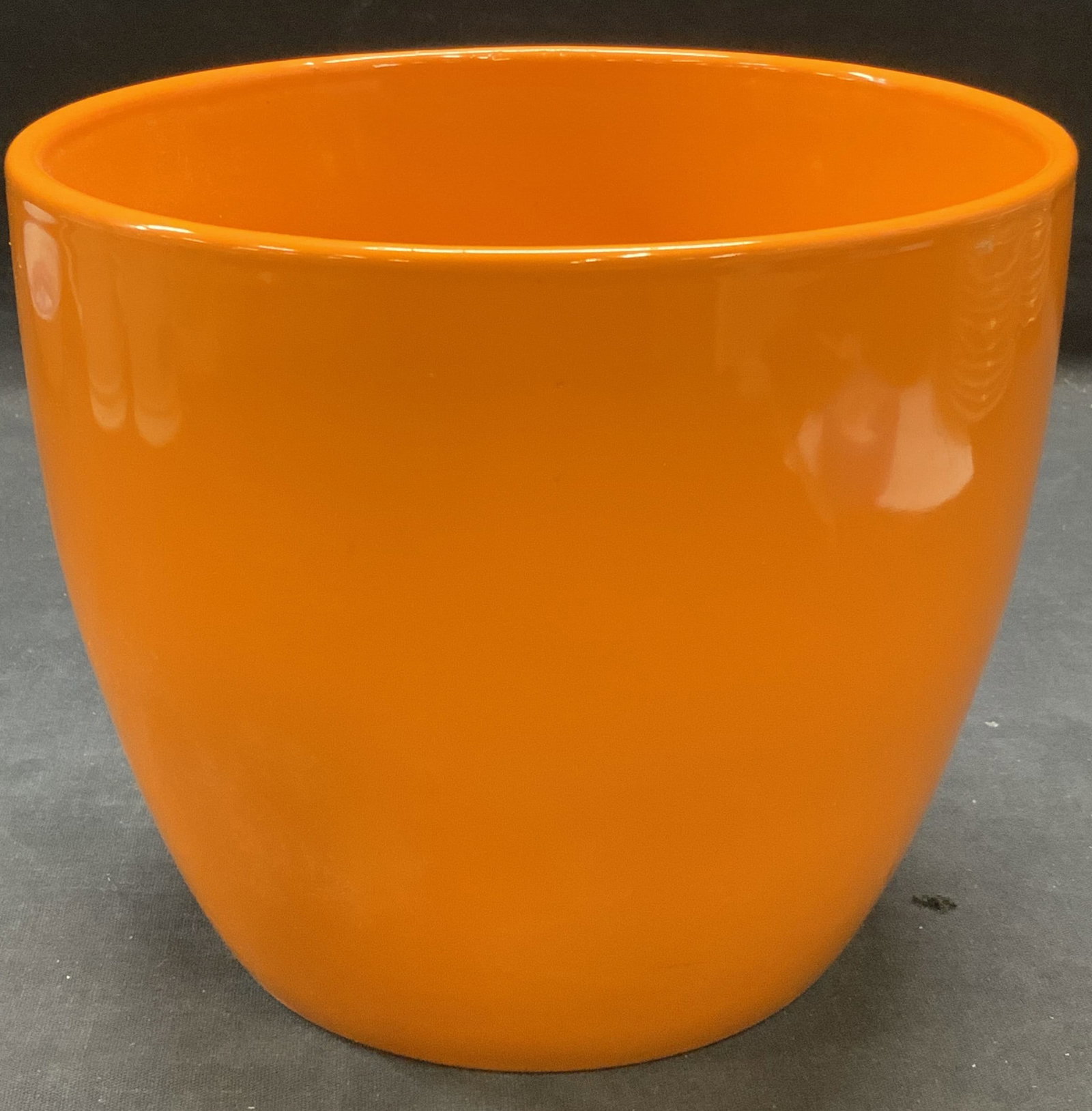 Orange Ceramic Planter: Orange glazed ceramic planter. Measures approx. 7 x 6 inches. Some surface wear including scratching observed. Planter, ceramic planter, orange planter, garden decor and accessories, home decor and ac