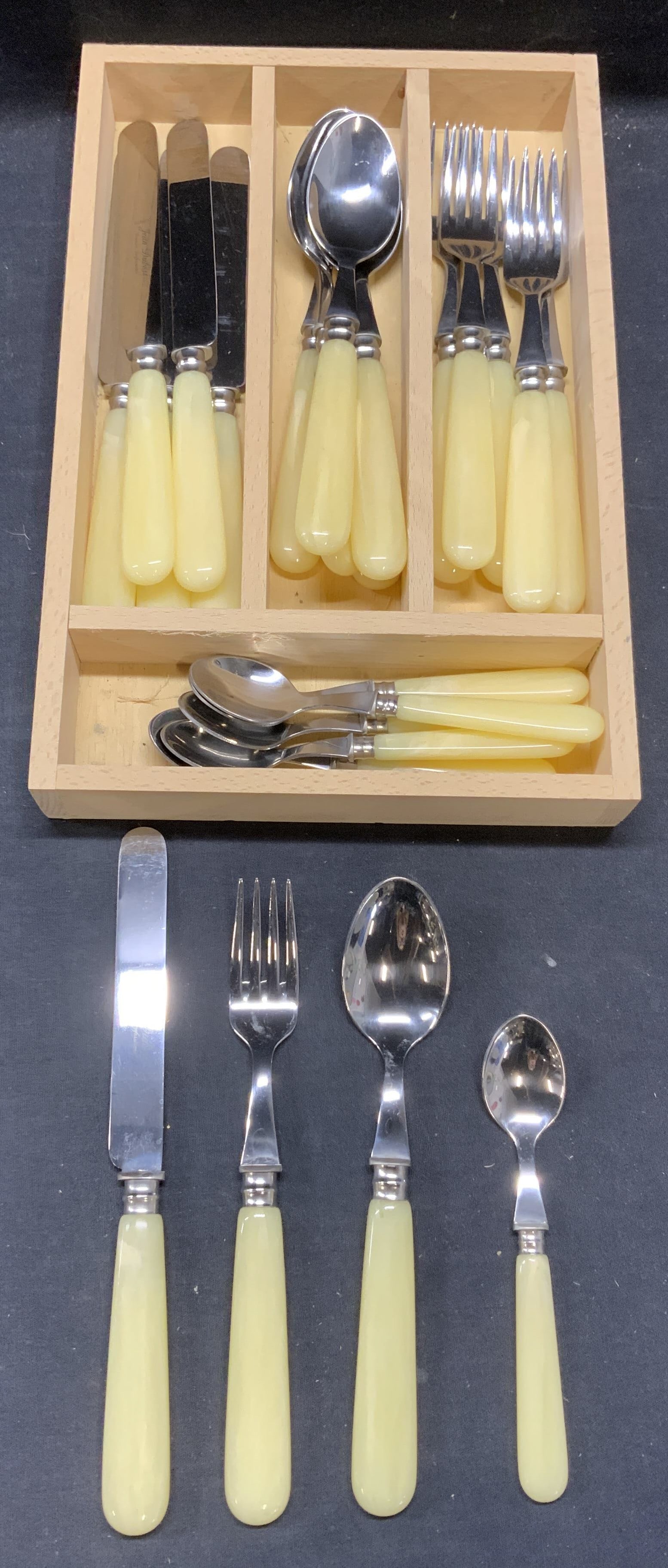 Set 24 Jean Dubost Cream Flatware, France: Set of 24 pieces Jean Dubost cream toned handle flatware. Acrylic handles with stainless steel. Signed on butter knives. Made in France. Includes 6 teaspoons, 6 tablespoons, 6 large forks, and 6 butte