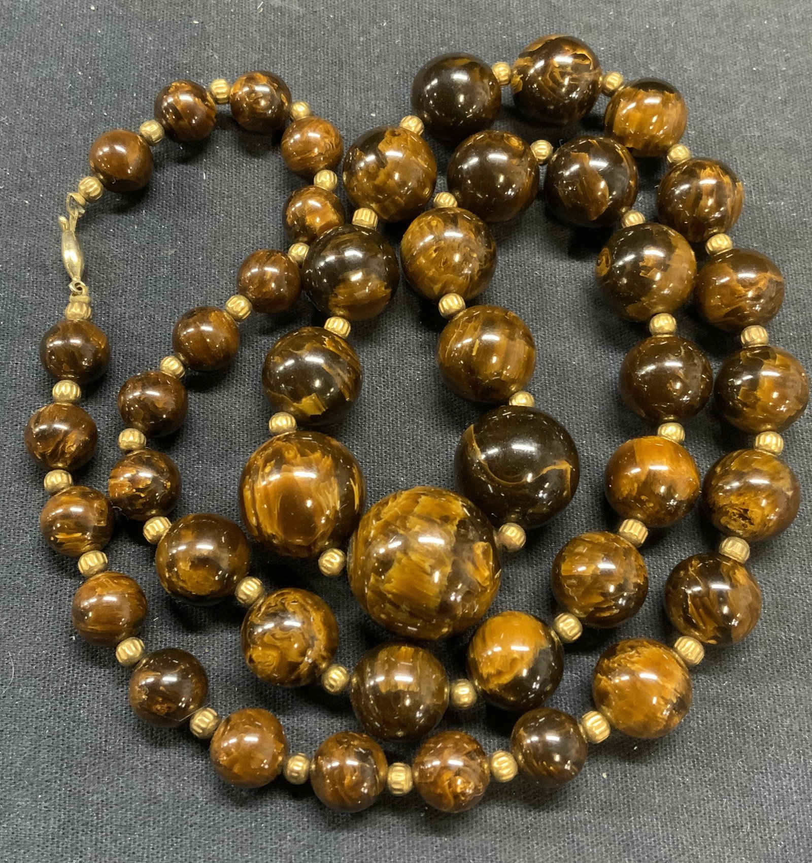 Brown Marbled Beaded Necklace: Brown marbled round beaded necklace with gold tone seed beads. Drop length approx. 14 inches. Some scratching observed. Estate jewelry, costume jewelry, cocktail jewelry, fashion jewelry, accessories,