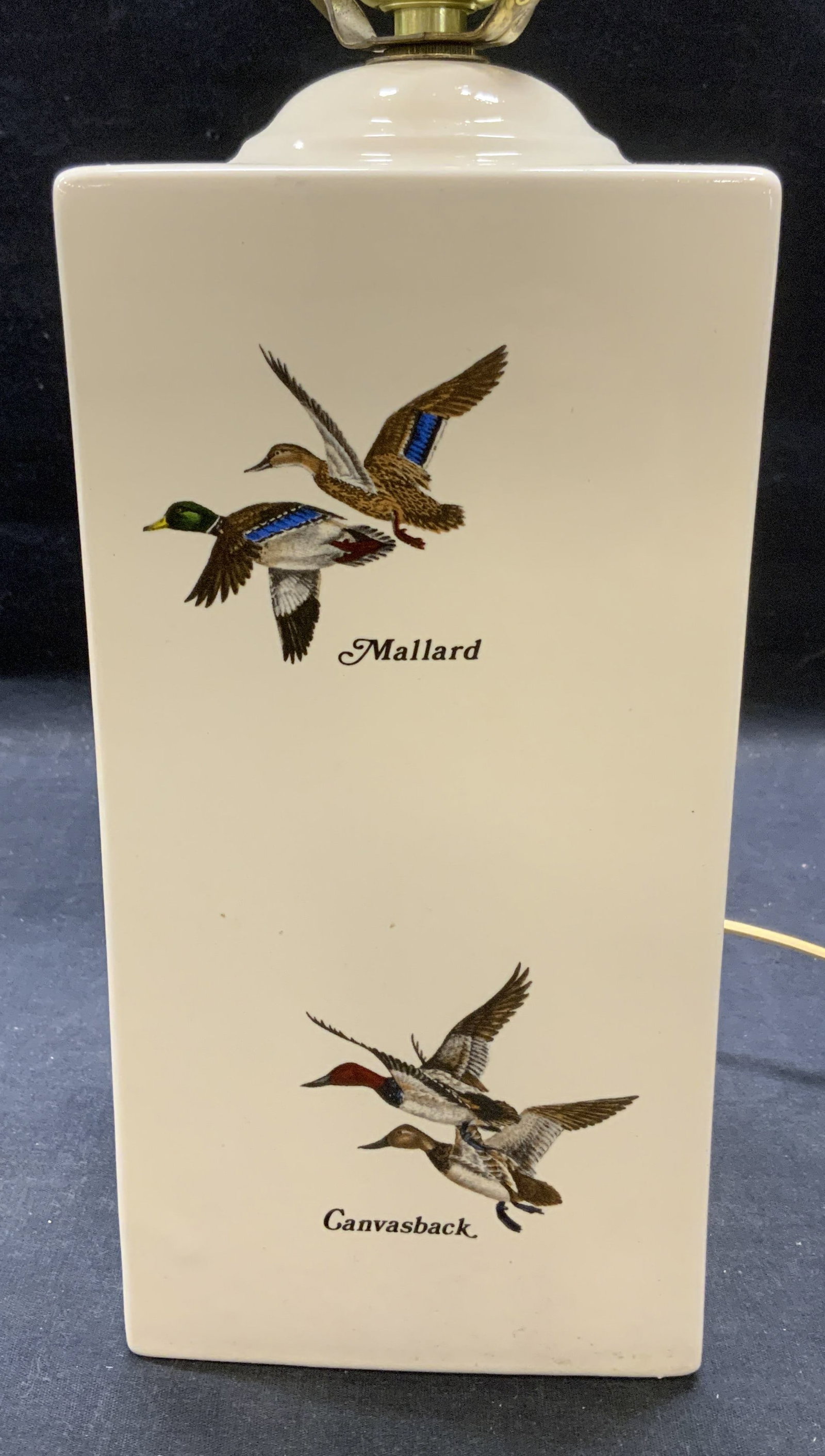 Jenny Designs Porcelain Duck Lamp: Jenny Designs porcelain table lamp with duck motif. Trademarked to underside. Measures approx. 5 x 5 x 9.5 inches. Not tested for function. Some scratching observed. Jenny designs, Jenny designs lamp,