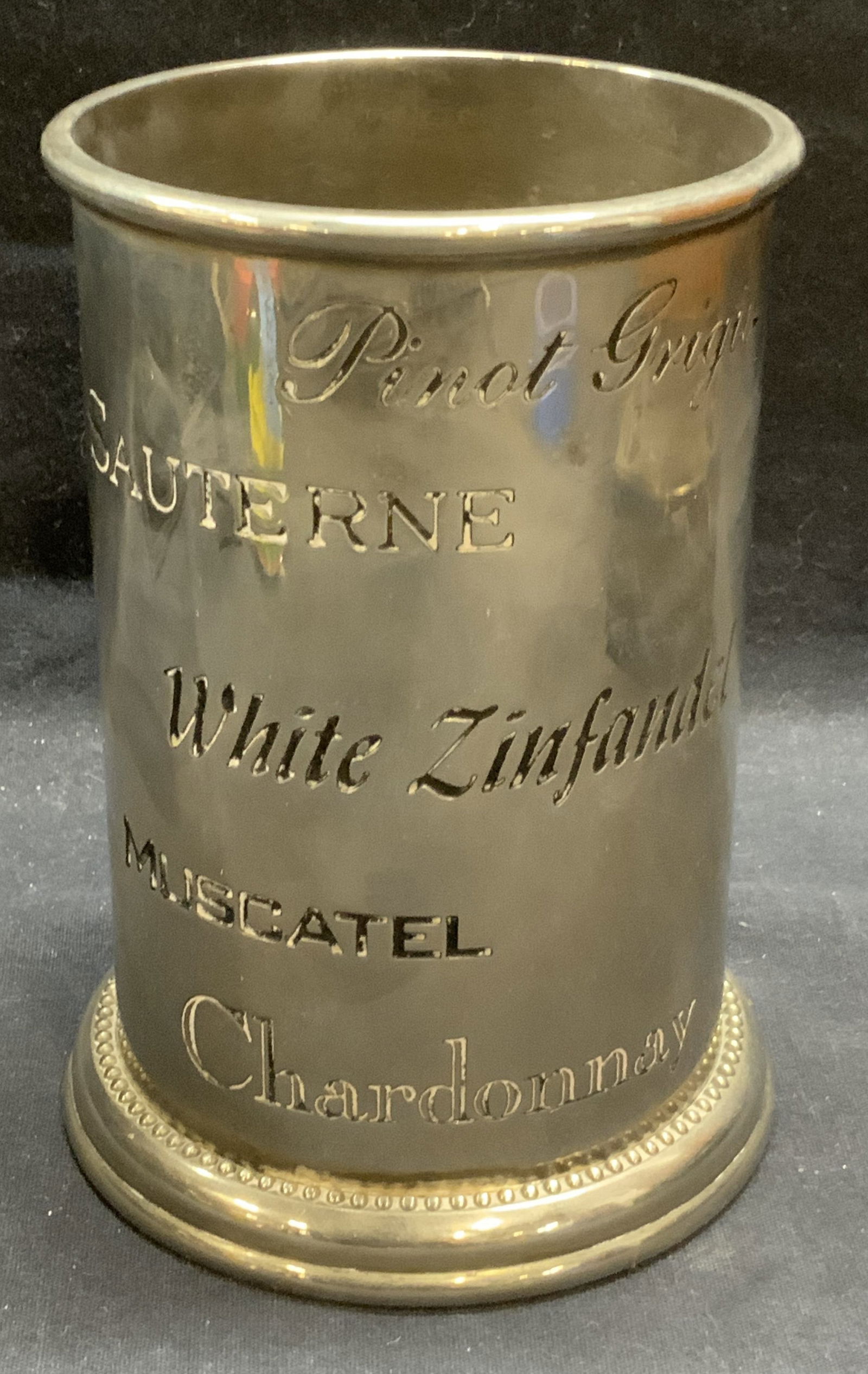 Vtg GODINGER Silver Plated Wine Bottle Holder: Vintage GODINGER Silver Art Co silver plated wine bottle holder with etched wine lettering. Trademarked to underside. Measures approx. 4.5 x 6.25 inches. Some scratching observed. GODINGER, GODINGER s