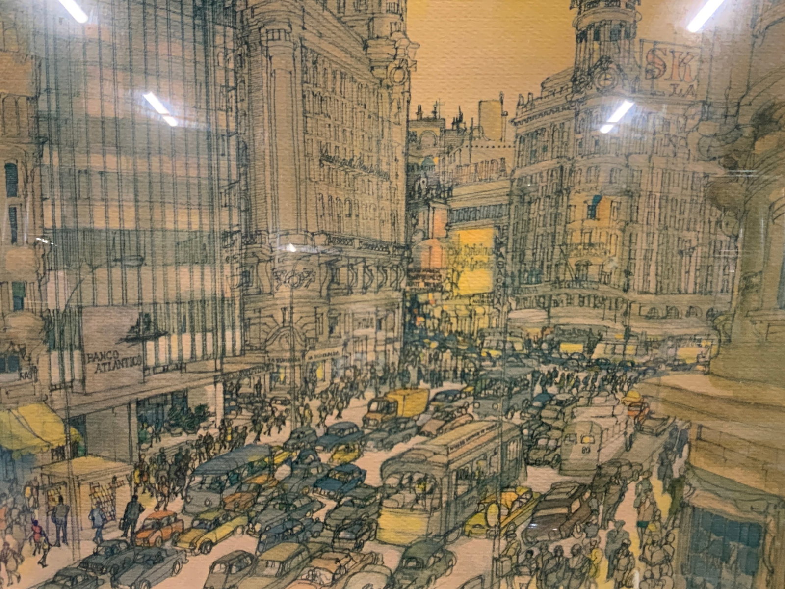 Vtg European Cityscape Lithograph: Vintage lithograph of a cityscape with traffic filled streets and tall buildings. Frame sun a gold toned and wooden frame with off white mat board, approx 16 x 20.5 inches window measures 11 x 14 inch