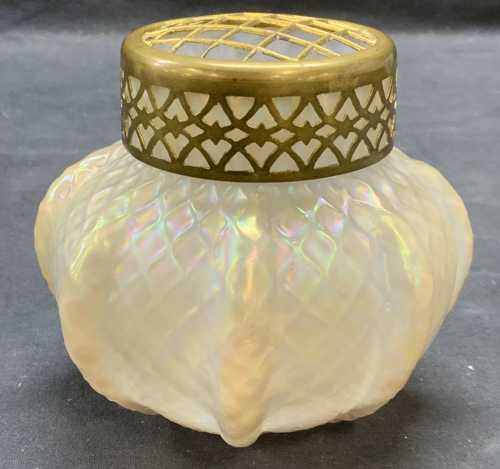 Vintage Opaline Art Glass Lidded Jar: Vintage iridescent opaline art glass jar with brass lid. Pierced lid detail. Ribbed textured surface jar. Measures approx. 4.5 x 4.25 inches. Some surface wear including scratching observed. Art glass