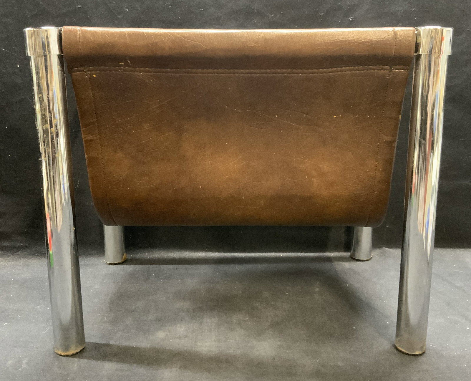 Silver Tone Brown Faux Leather Magazine Rack: Silver tone frame magazine rack with brown toned faux leather. Measures approx. 18 x 12 x 14.75 inches. Some surface wear including scratching and wear to leather observed. Magazine rack, silver tone 
