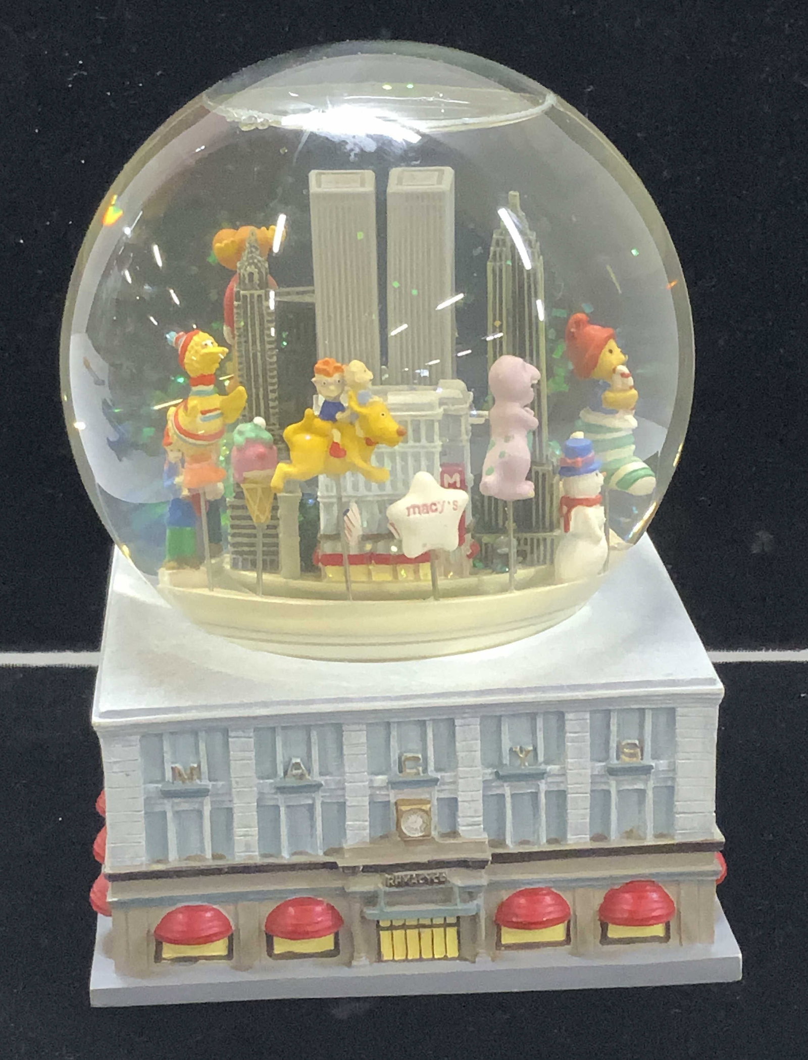 Vintage MACYs Thanksgiving Parade Musical Globe: Macys Herald Square Building musical globe featuring a Macys Thanksgiving Day Parade with balloons circling the vintage skyline of NYC. Big bird, Moose, Turkey, Statue of Liberty, & Barney the Dinosau