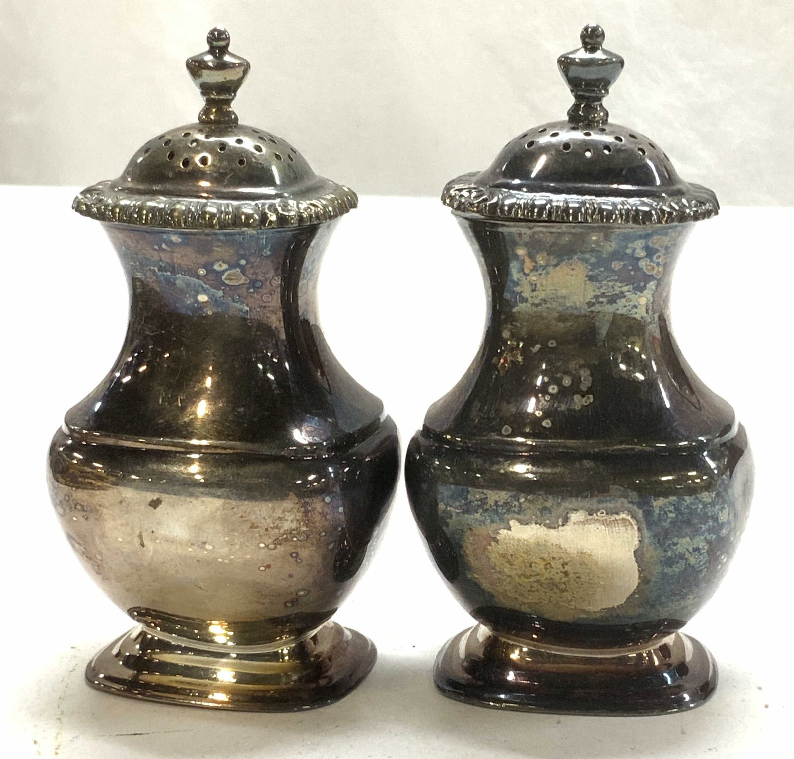 Sterling silver & Plated Salt & Pepper Shakers, 2: Pair of salt and pepper shakers. Silver plate with sterling silver lids ( 51 grams) Underside is hallmarked . Measure 4 in ht., 2 x 1.5 in. Lids test positive for sterling with PuriTEST kit. Tableware