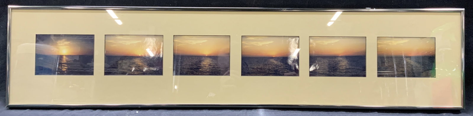 Six Sunset Photography Panels: Lot of 6 sunset photography panels. Depicting the sun during the sunset progressively disappearing behind the horizon. Framed in a chrome toned metal frame with tan toned mat board, approximately 8.25