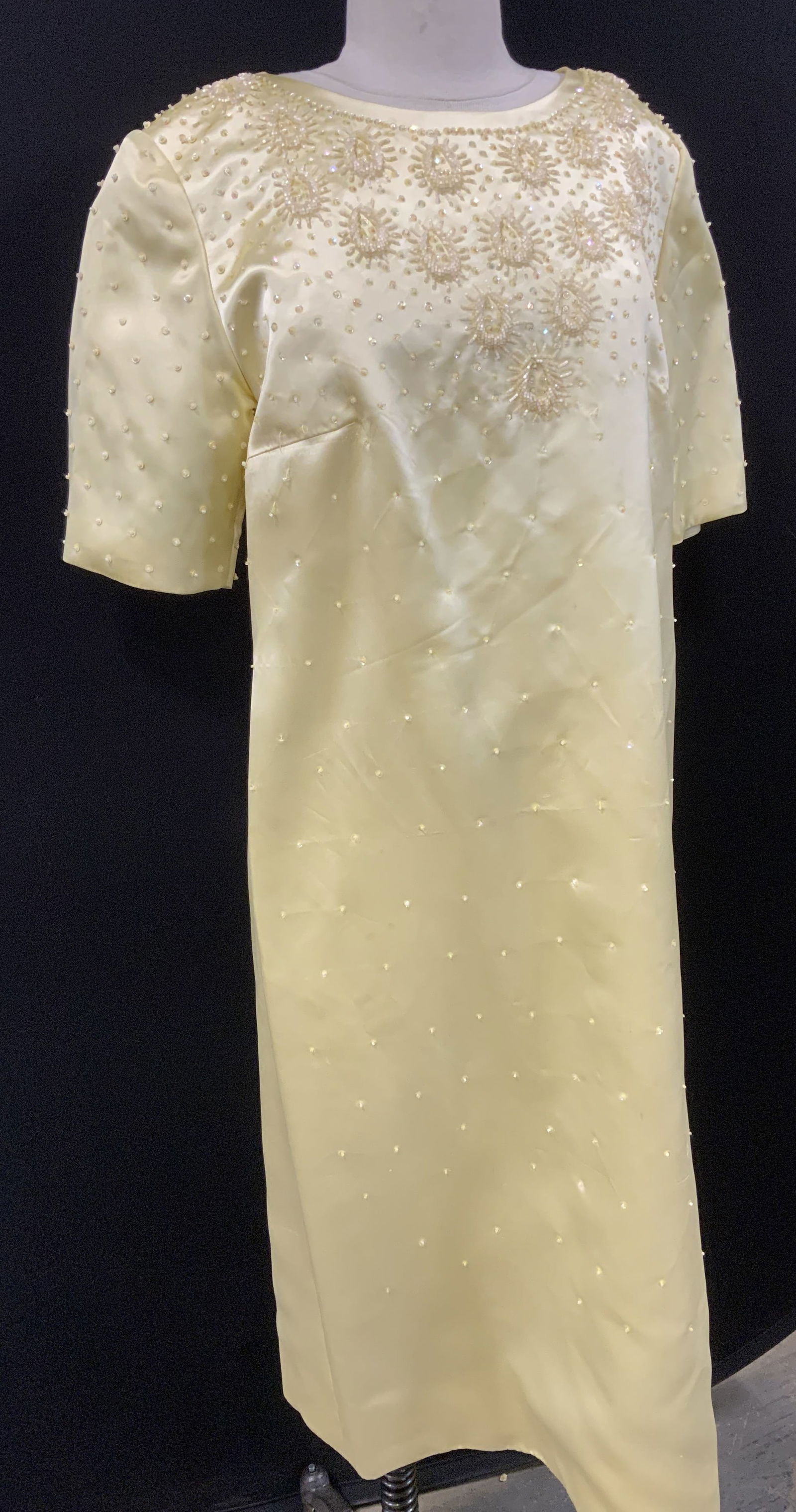 Mid Century Beaded Cocktail Dress: Bespoke cocktail dress in pastel yellow , shiny and silky polyester fabric with hand beading , shirt sleeves, crew neck, backside zipper and cotton lined. 38 in waist/ hips. Some loose threading that