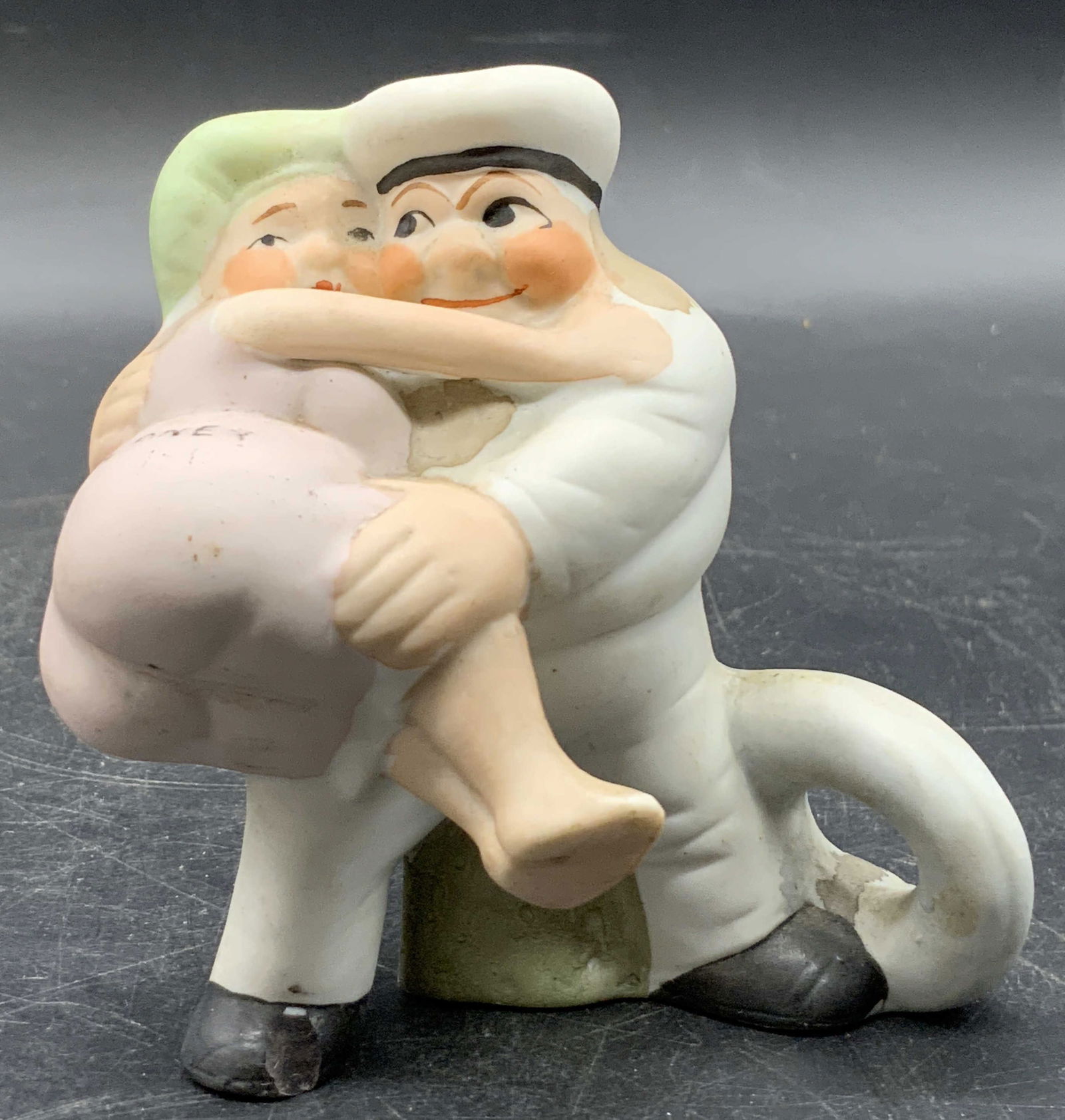 CONEY Bisque Porcelain Sailor Toothpick Holder: Vintage Sailor holding onto his wife bisque porcelain toothpick / matchbook holder. The wife has the word CONEY written on her rear. Hand painted details. Measures approx. 3.5H x 3.25W in. Some discol