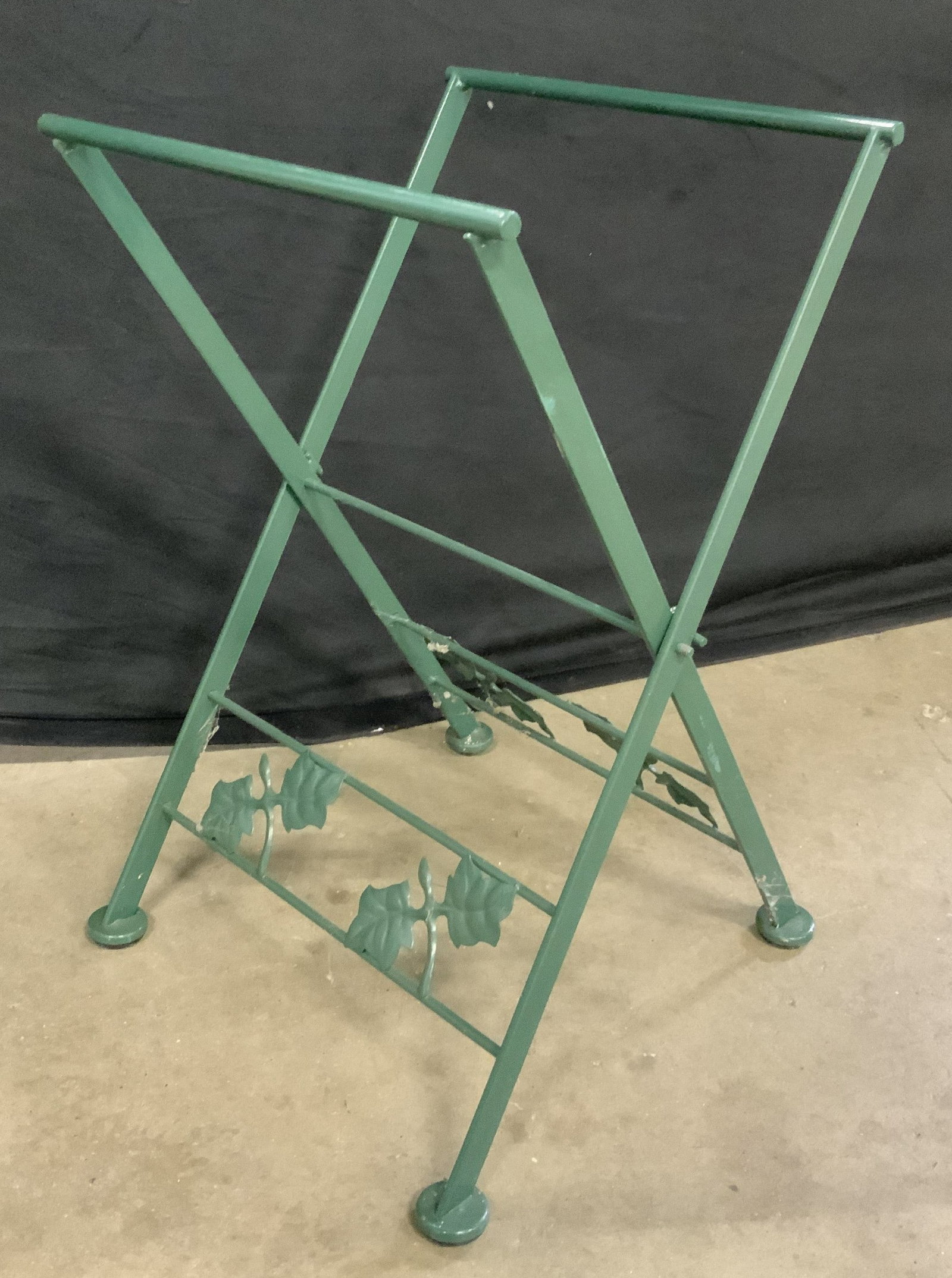 Vintage Green Metal Folding Rack: Vintage green enameled metal folding rack. Botanical leaf detail. Measures approx. 12 x 12.5 x 19.5 inches. Some surface wear inclusion scratching observed. Folding rack, rack, metal rack, metal foldi
