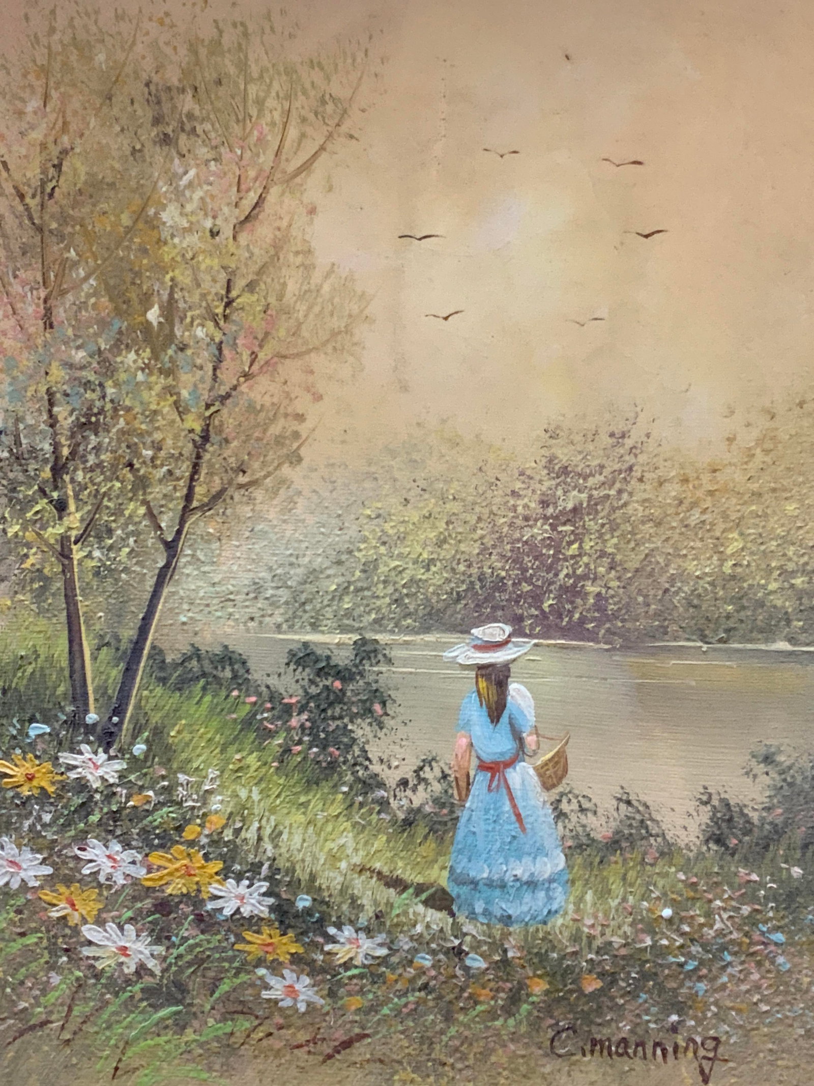 C.Manning Sgd Vtg Oil Painting: Signed C. Manning. A oil painting depicting a woman in a blue dress with a basket in hand looking at a lake lush with nature. Framed in a wooden and black toned frame. Approx 17 x 15 inches window mea