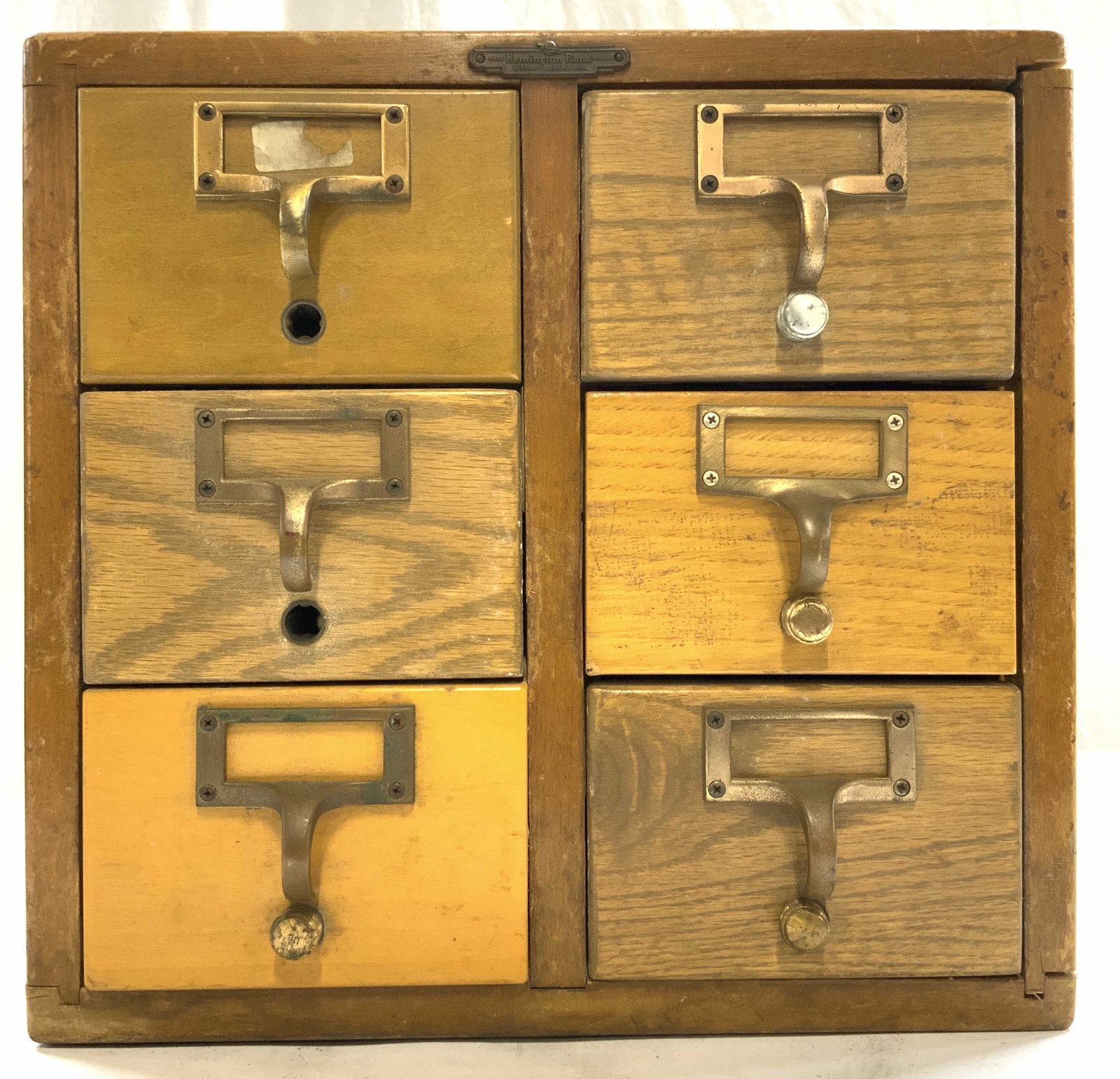 REMINGTON RAND Library Bureau Div Card Catalogue: REMINGTON RAND LIBRARY BUREAU DIV MADE IN USA. Piece is tan toned and wooden. Chest has 6 drawers each with gilt metal handles. Piece measures approximately 18 inches deep 13.5 inches tall and wide. L
