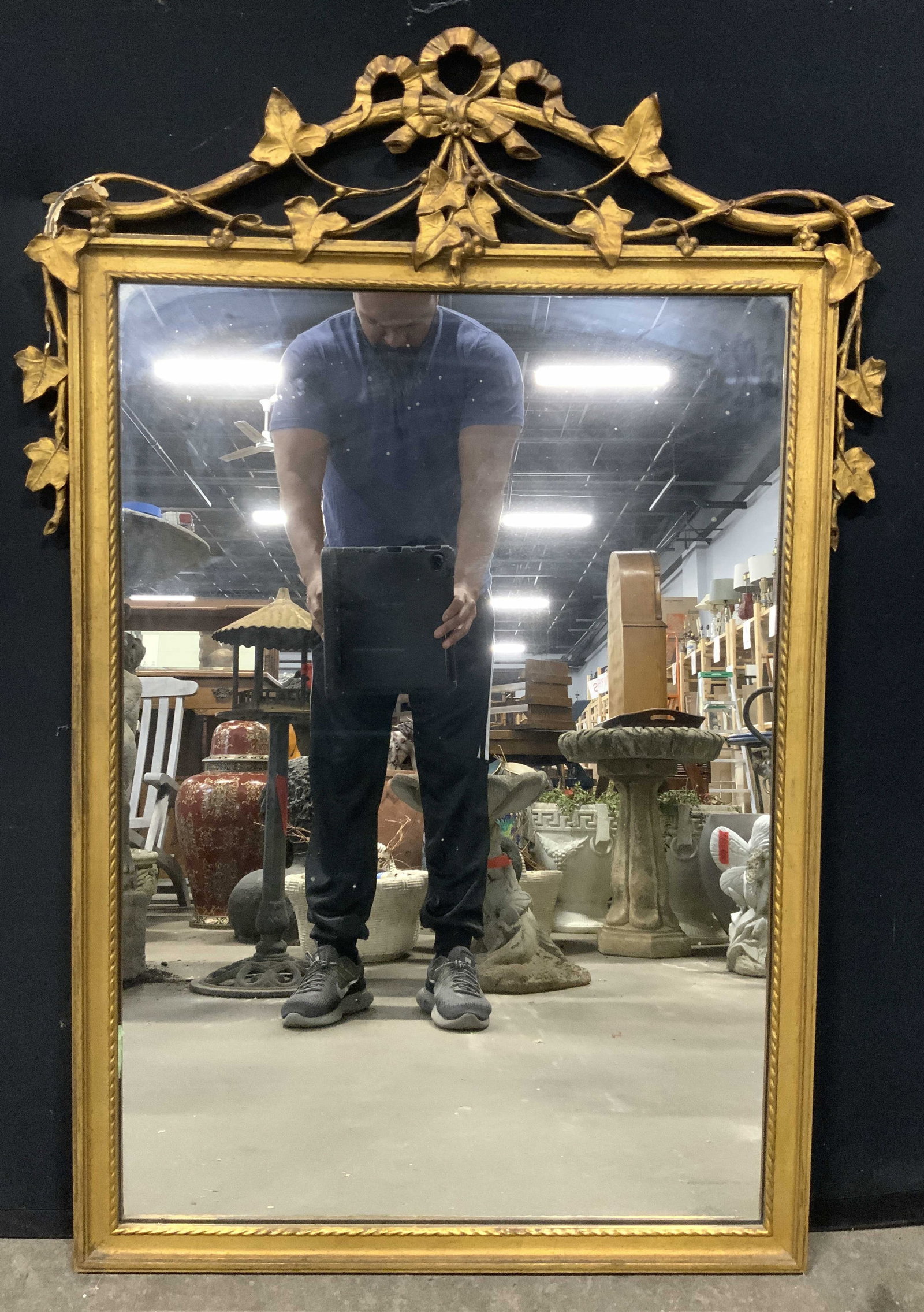 Vintage Victorian Ornate Gilt Wood Mirror: Mirror is vintage. Piece has gilt wood frame with leaf, vine & ribbon detail. Mirror has portrait orientation. Measures approx 44 inches tall 30 inches wide. Mirror, wall mirror, Giltwood mirror, Gilt