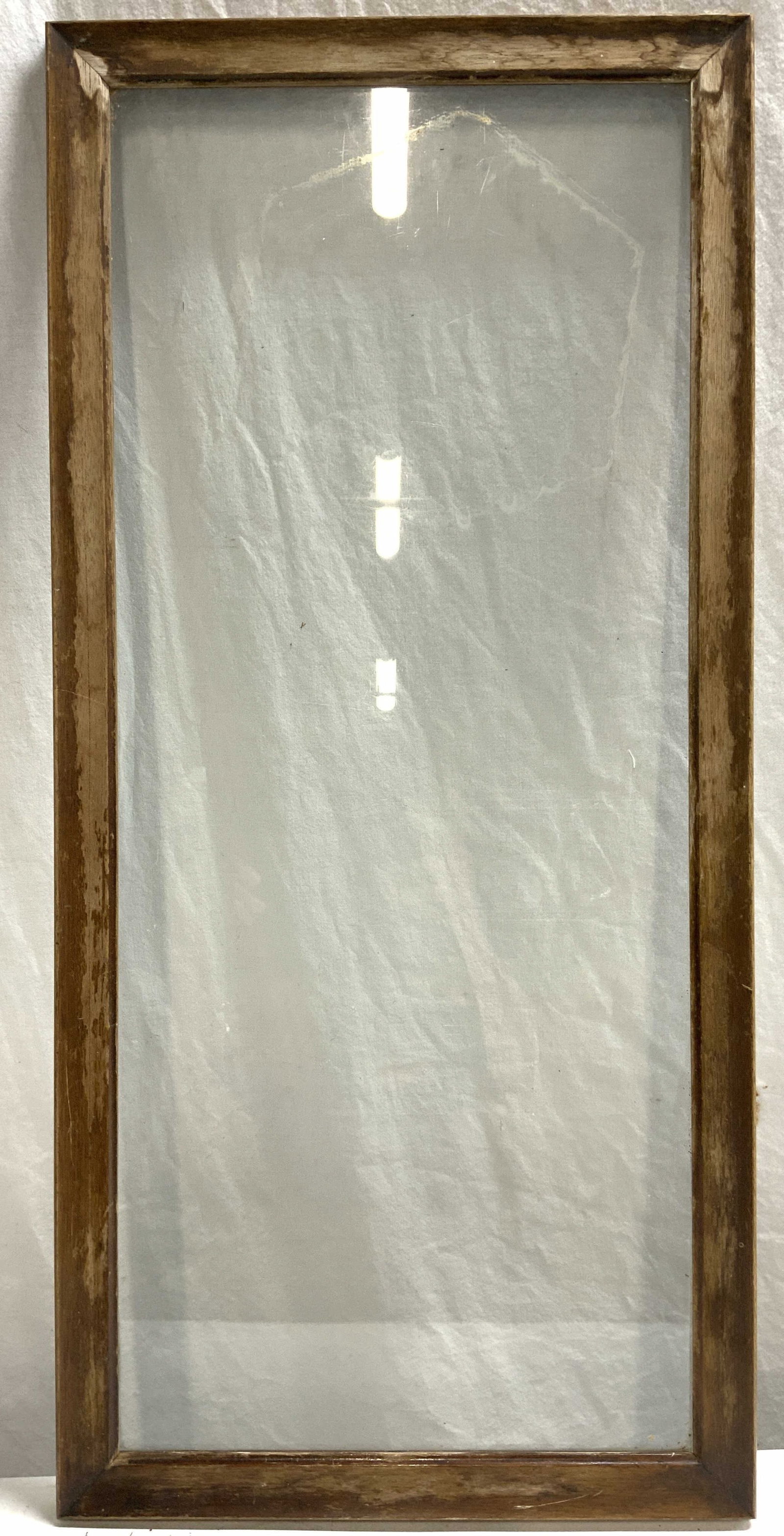 Vintage Wooden Frame W Glass Window: Frame is brown toned and wooden. Piece is vintage. Frame has elongated rectangular shape. Frame has glass window. Piece measures approximately 30 inches tall 14 inches wide. Frame, wooden frame, vinta
