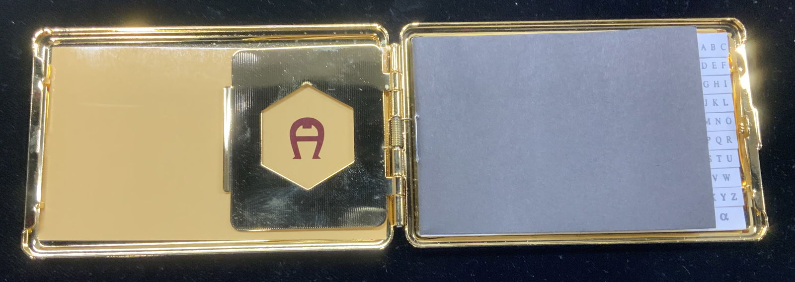 Etienne Aigner Hinged Card Holder/ Phone Bk: Never used Etienne AIGNER designer pocket or pocketbook accessory. Gold tone metal business card holder / mini travel phone book. Will also hold some dollar bills. measures 3.75 in. Long x 2.25 in. Wi