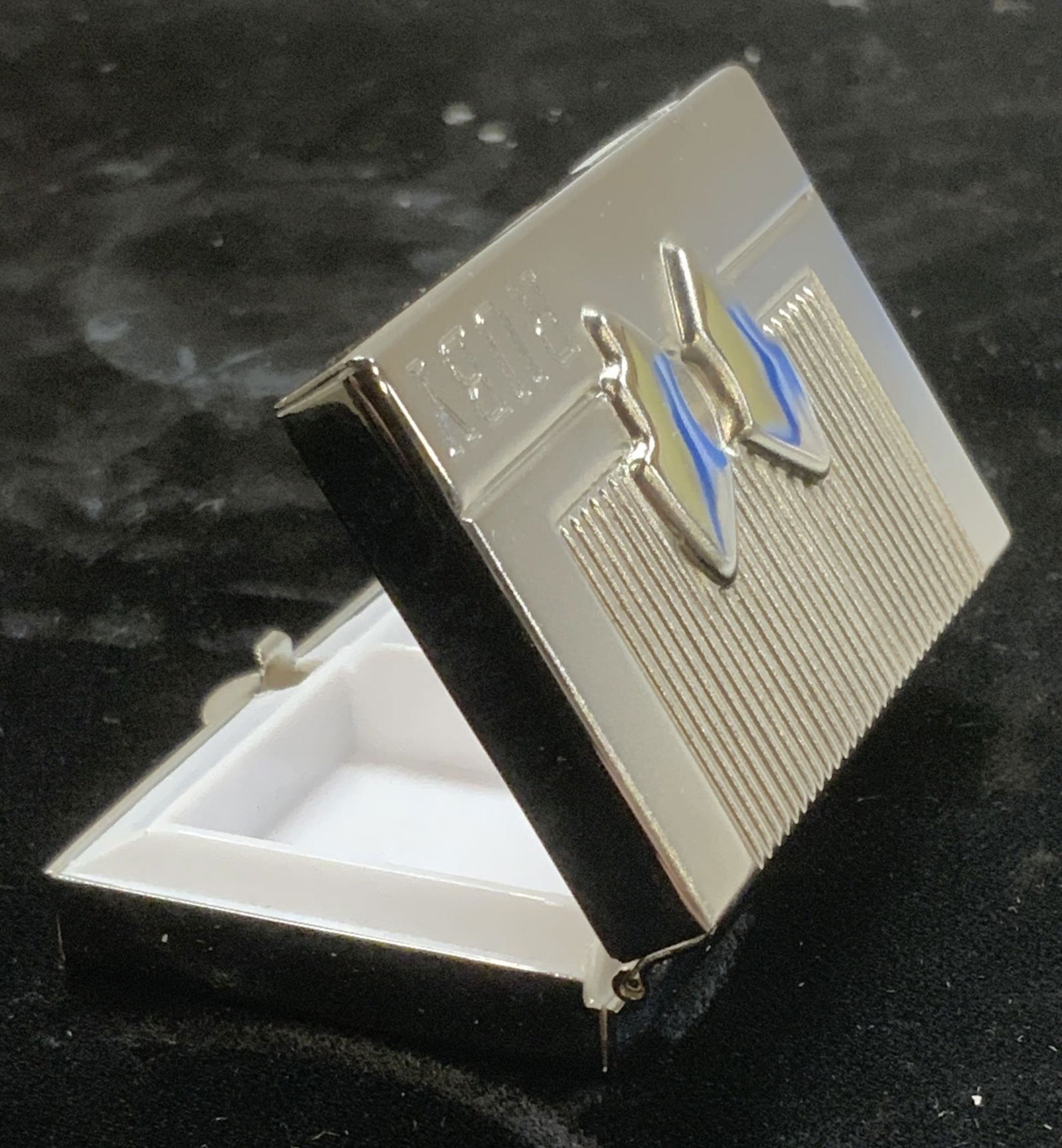 RUBY Brushed Hinged Metal Pill Box: Silver tone hinged pill box with bow on front. RUBY inscribed onto the lid and the name STEPHANIE inscribed onto the side edge. Measures 2 x 1.5 in. Appears never used. Pill box, pocketbook purse pill