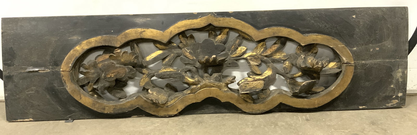 Vintage Gilt Wood Wall Carving: Wall carving is vintage and wooden. Piece is black and golf toned with gilt detail. Piece has carved floral & leaf detail. Wood carving measures approximately 64 inches long 17 inches tall. Wood carvi