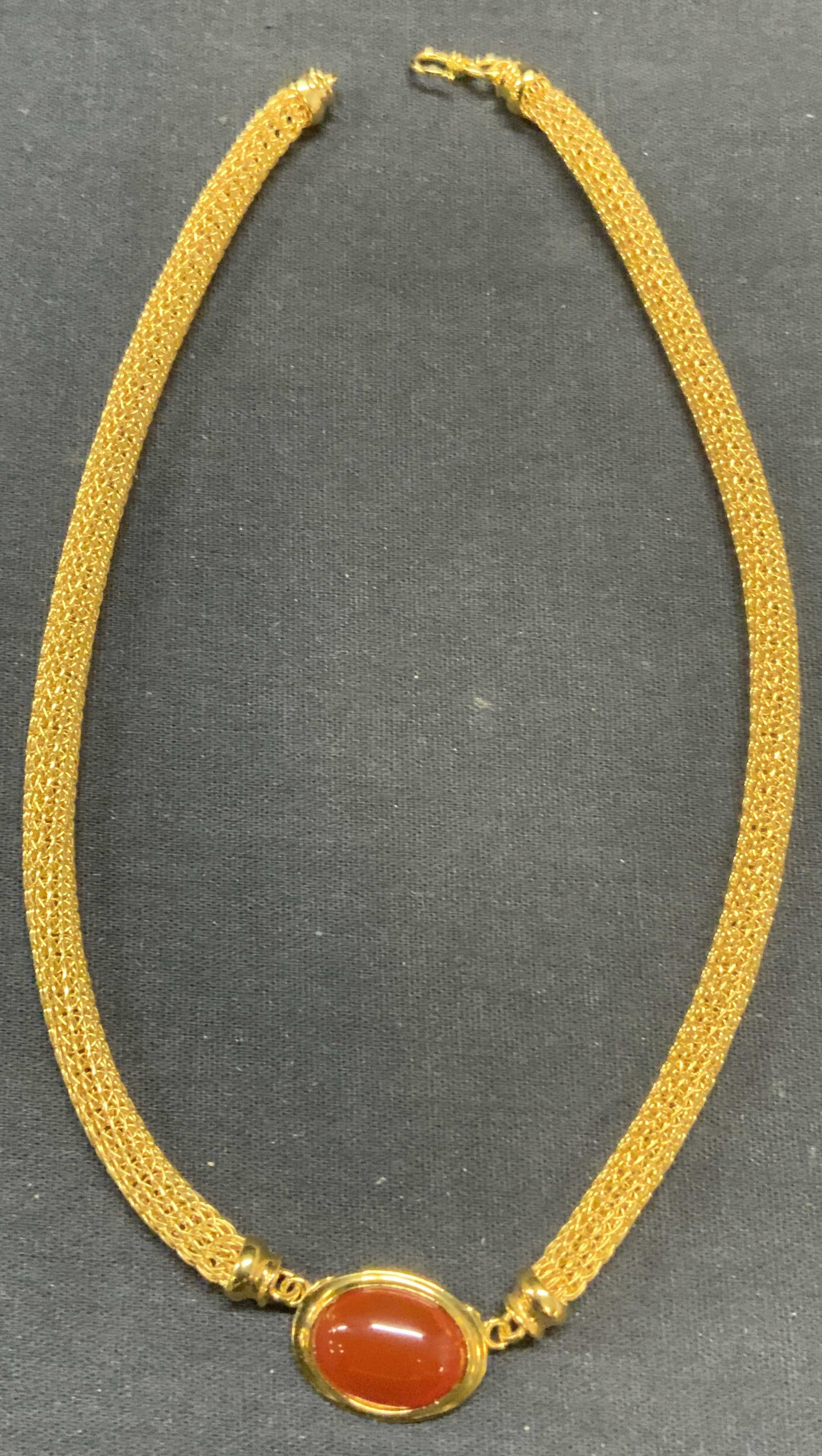 MMA Gold Pl Mesh Chain Red Stone Necklace: Metropolitan Museum of Art gold plated mesh chain choker necklace with red natural stone pendant. Signed on pendant. Drop length approx. 6.5 inches. Some surface wear including scratching observed. Es