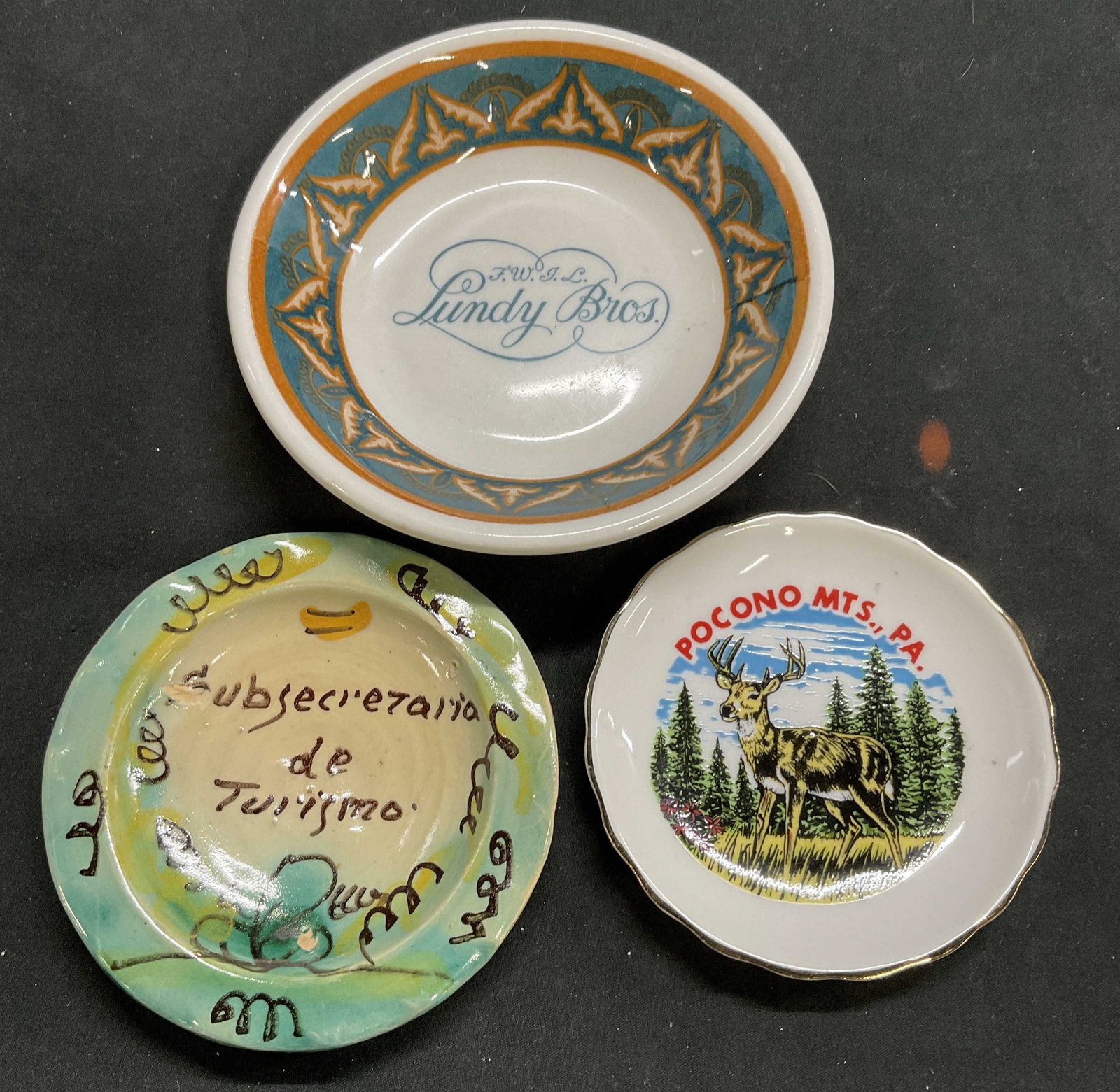 Lot 3 Souvenir Ashtrays, Poconos, Lundy Bros, More: Lot 3 Souvenir Ashtrays. Pocono Mts. Measures approx. 3.5 in diameter. FWIL Lindy Bros. Stamped on reverse: Shenango, China. Newcastle PA. Measures approx. 5in diameter. Subsecretaria de Turismo. Meas