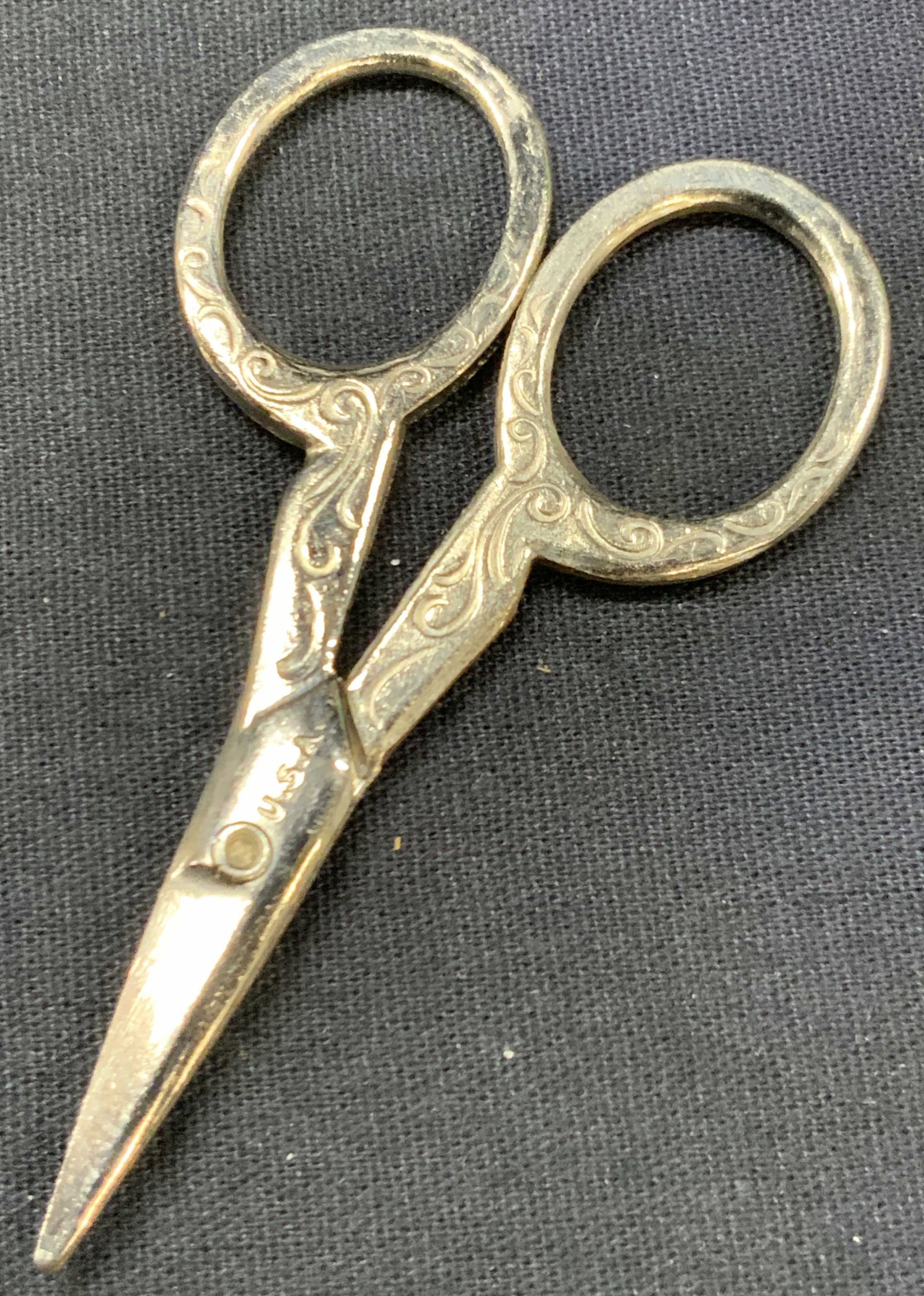 Etched Steel Sewing Scissors, U.S.A.: Marked u.s.a on handle. Pair of sewing scissors with scroll etchings throughout the handles, approx 3 inches long. Minor wearing to metal due to age and use. Etched steel scissors. Sewing scissors, et