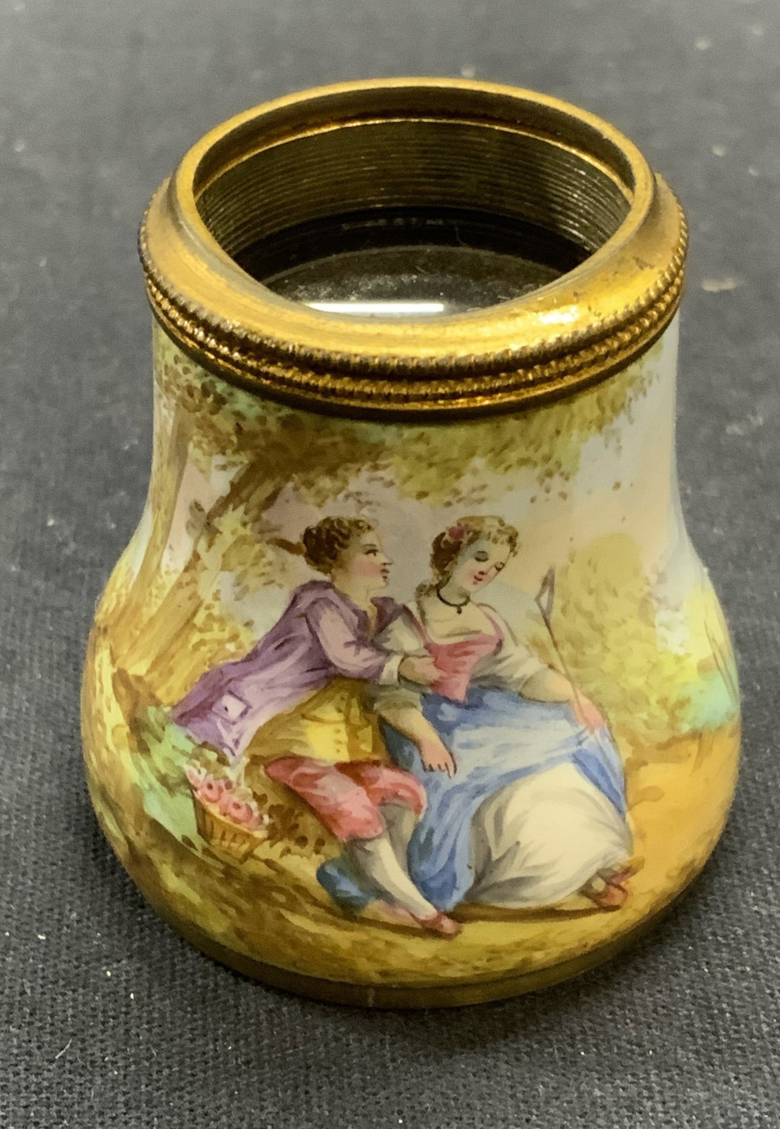Vintage Enamel Magnifying Glass: Vintage enameled Metal magnifying glass with figural motif. Appears to be a binocular component. Measures approx. 1.5 x 1.75 inches. Some surface wear including scratching observed. Magnifying glass, 