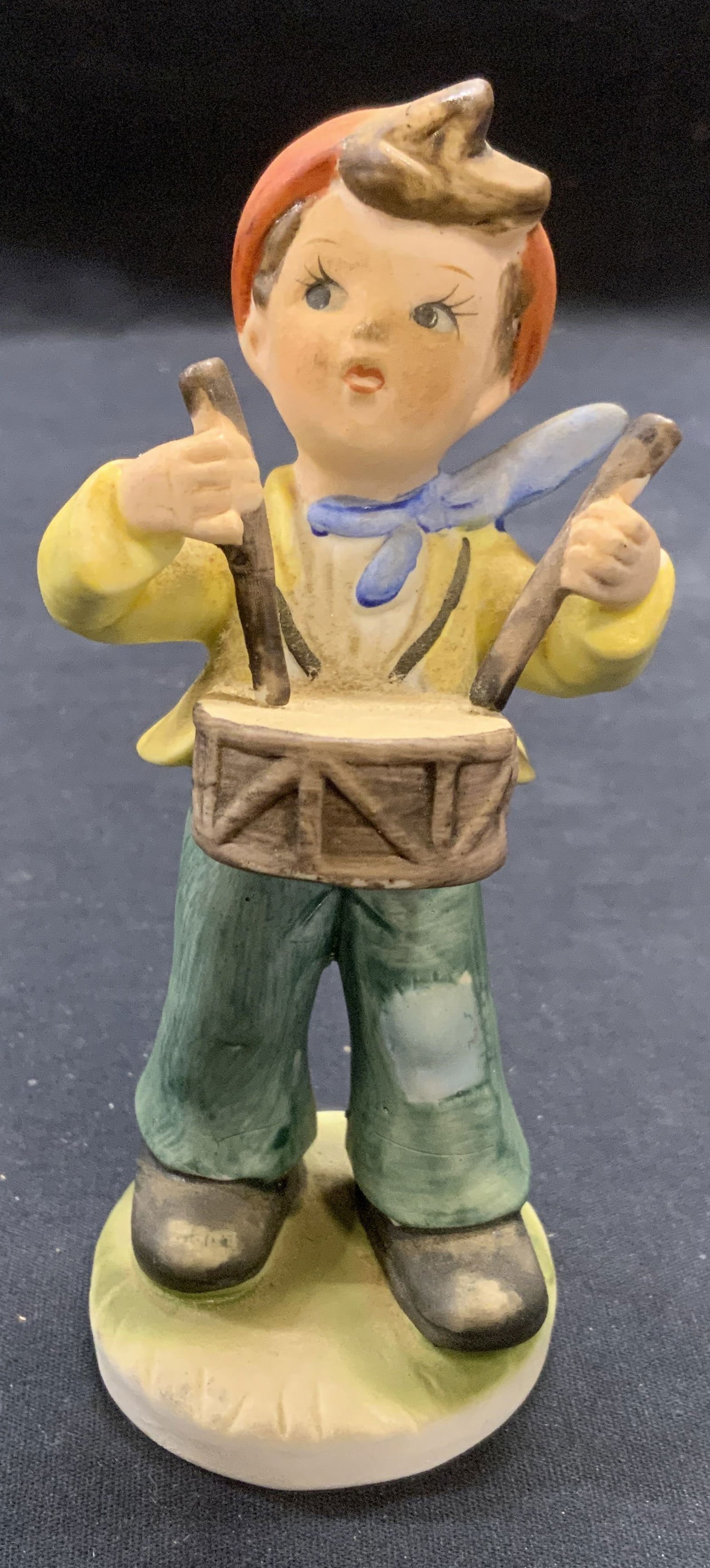 Vintage Porcelain Drummer Boy Figural: Vintage porcelain figurine. Drummer boy motif. Hand painted. Measures approx. 2.25 x 2.5 x 5.25 inches. Some surface wear including scratching observed. Porcelain figurine, figurine, boy figurine, dru
