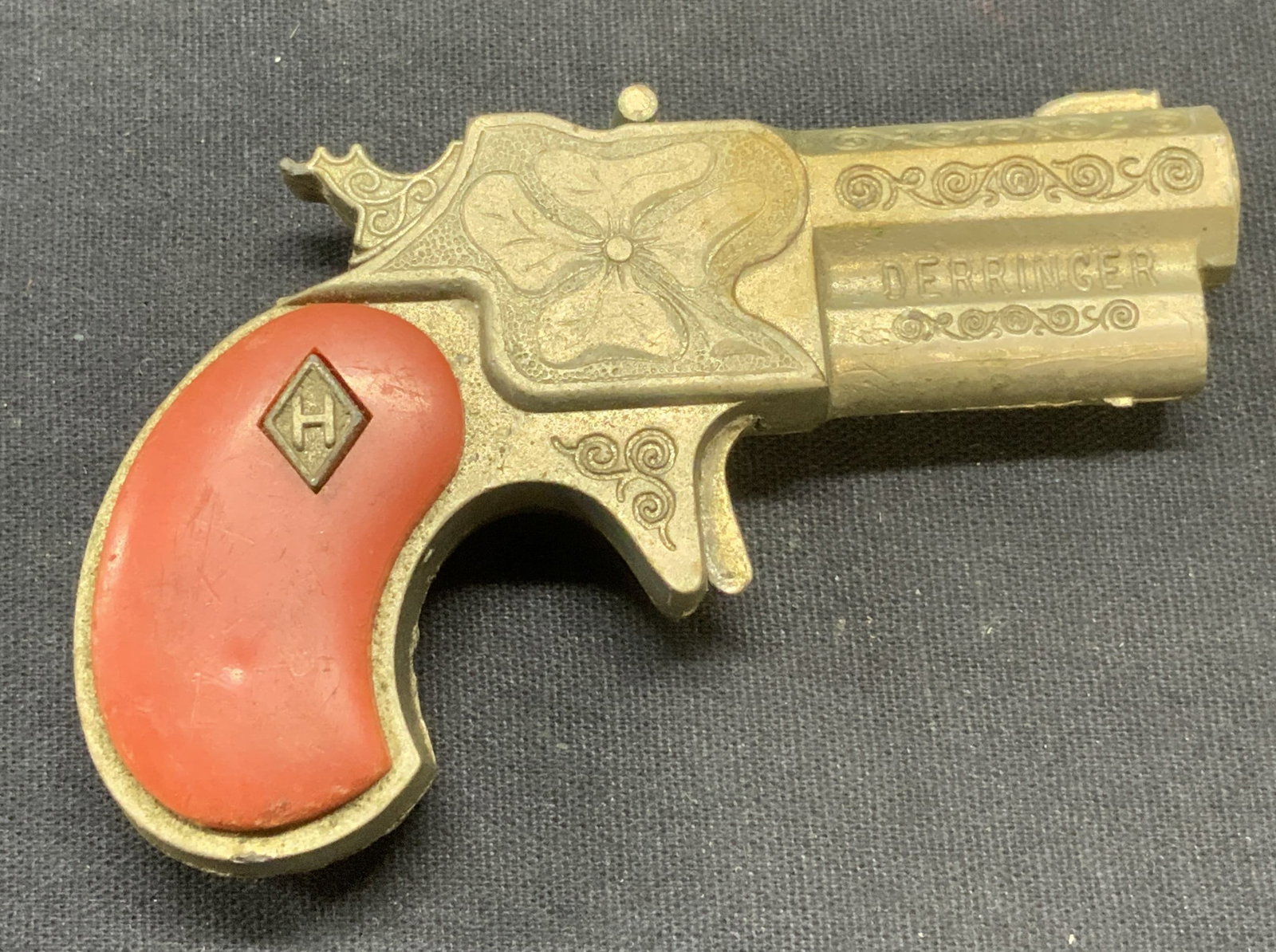 Vintage Derringer Metal Toy Gun: Vintage Derringer toy gun. Metal and acrylic. Embossed raised motif. Measures approx. 3.25 x 2.25 inches. Surface wear including scratching observed. Toy gun, derringer gun, vintage toy, vintage toy g