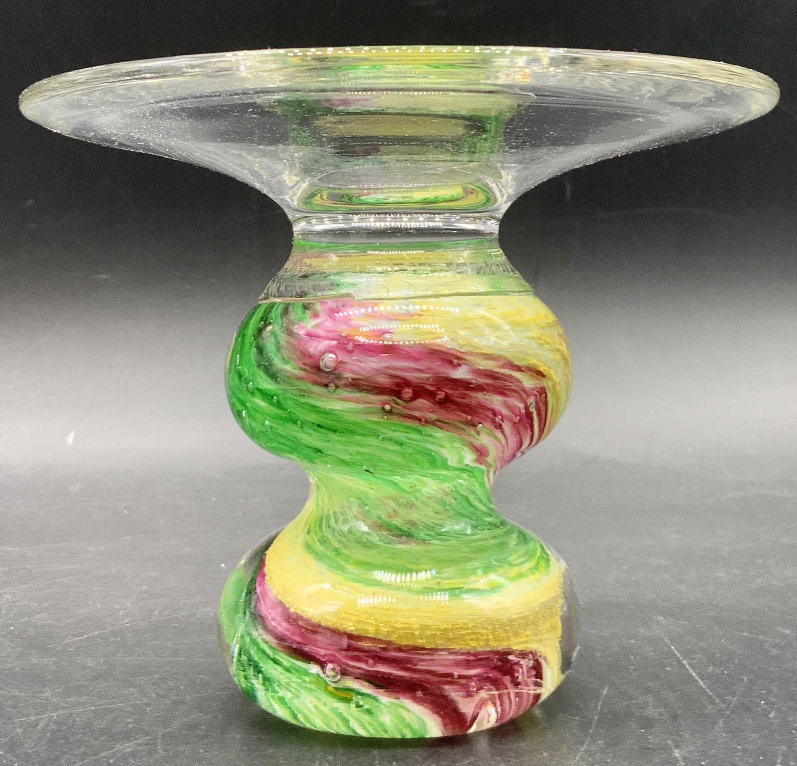 Vintage Art Glass Candle Holder: A vintage art glass candle holder featuring clear glass & multicolored glass swirls. Measures approx. 3.75H x 4.75W in. Some bubbles to the glass. Some wear consistent with age and use. Collectibles,