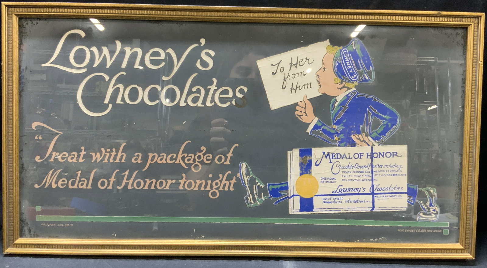 Vtg Lowneys Chocolates Advertisement: Vintage, possibly antique paper silk scene advert reading Lowneys Chocolates, treat with a palace of Medal of Honor Tonight. Depicting a delivery man in blue and green holding an enlarged chocolate ba