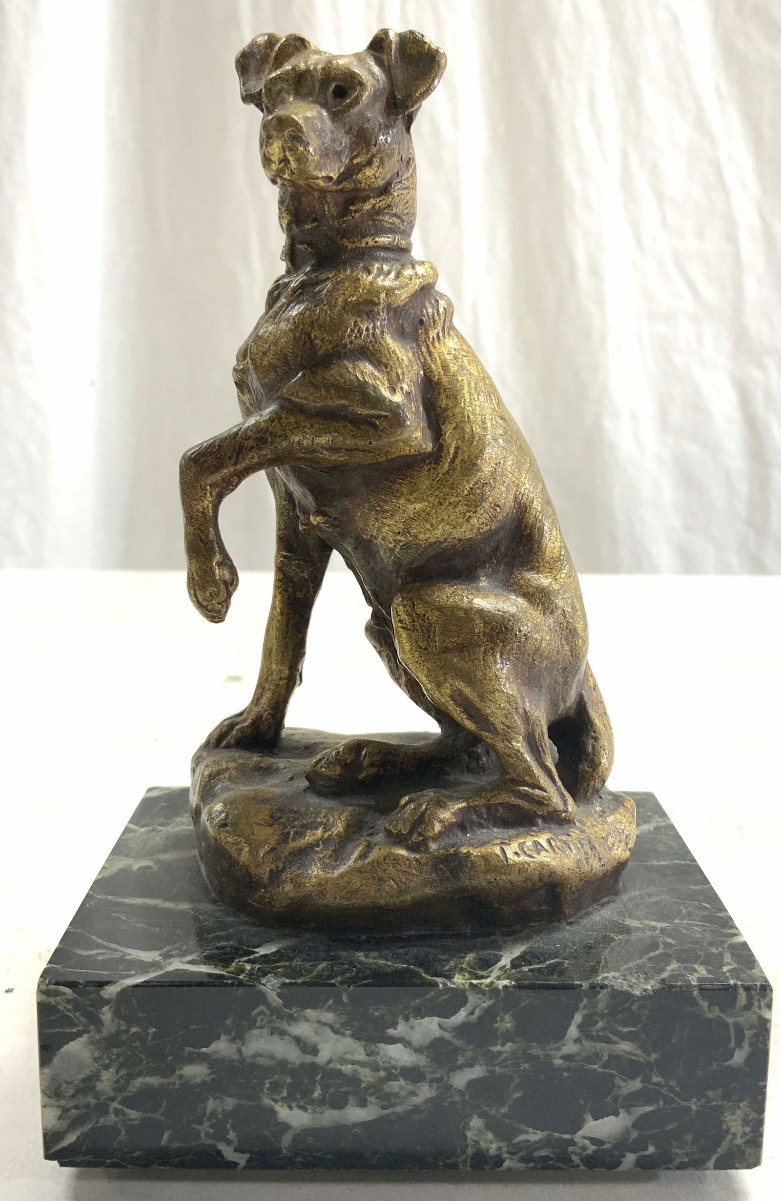 THOMAS CARTIER Gilt Bronze Fox Terrier Figural: Base of figure signed T CARTIER. Figure appears to be gilt bronze. Depicts a seated Fox Terrier with paw raised. Piece has forest green toned marble base. Figure measures approximately 6.25 inches tal