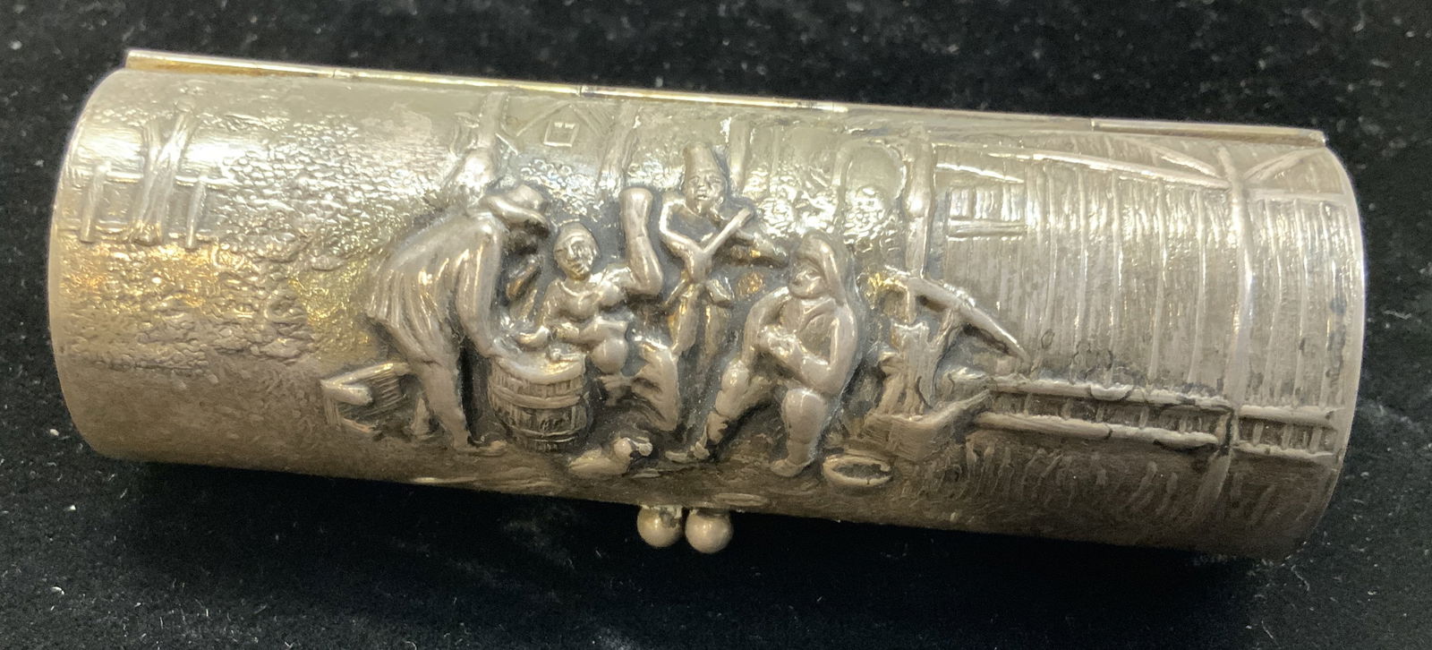 Antq Silver TN Repousse Lipstick Case, Denmark: silver tone metal lipstick hinged case. Possibly antique. Made in Denmark and marked Made in Denmark. Gold wash interior. Repousse barn scene Kiss clasp. . Measures 3.5 in. Long. 1+ in. diameter., up